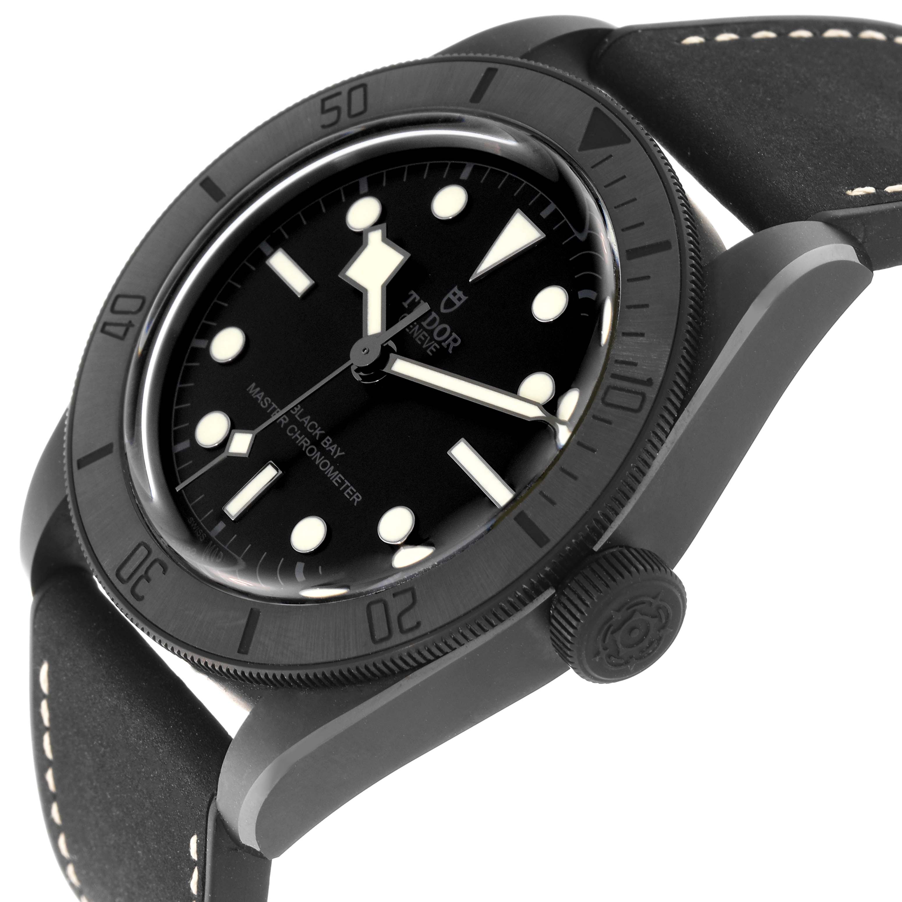 The photo shows the Tudor Heritage Black Bay 79210CNU Men
s Ceramic Black Dial 79210CNU Men
s Ceramic Black Dial watch from an angled top view, highlighting the bezel, face, crown, and strap.