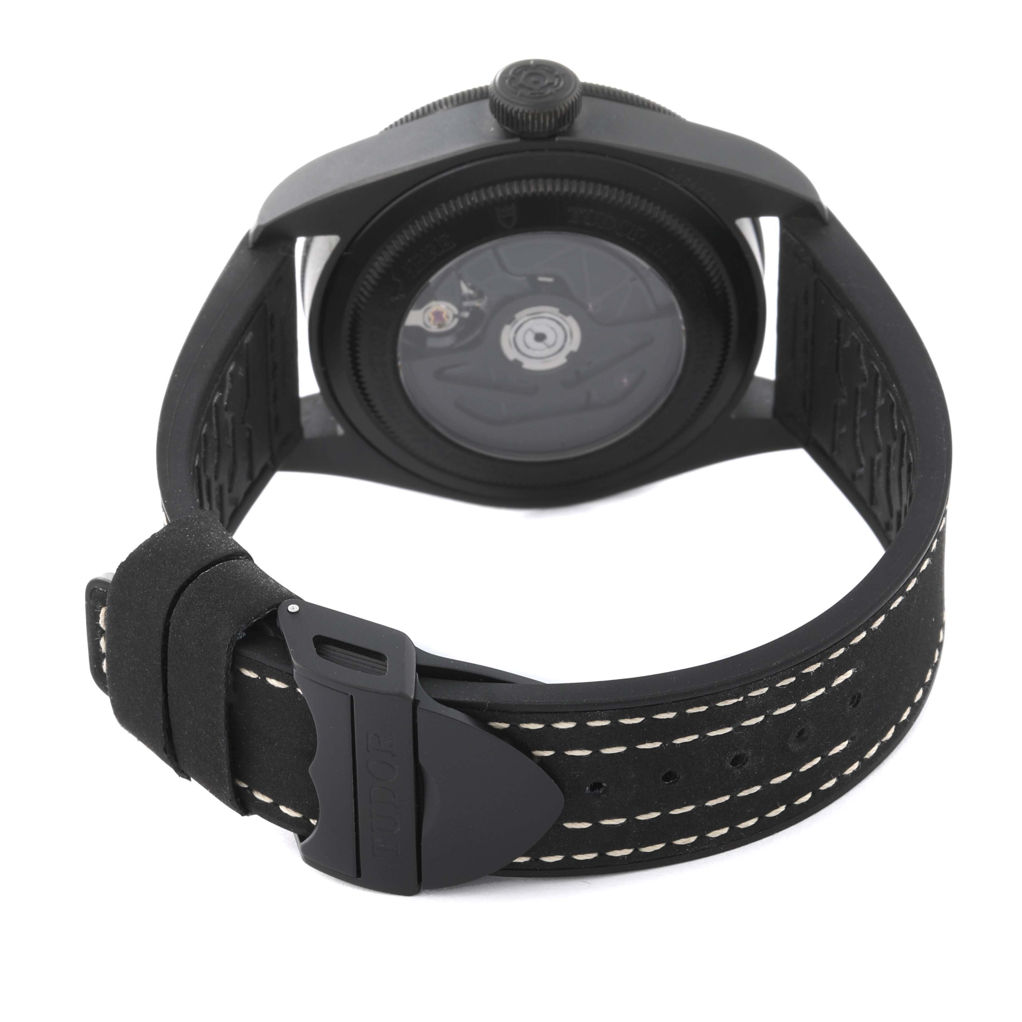 This image shows the back of a Tudor Heritage Black Bay 79210CNU Men
s Ceramic Black Dial 79210CNU Men
s Ceramic Black Dial watch, highlighting its case back and strap with buckle.