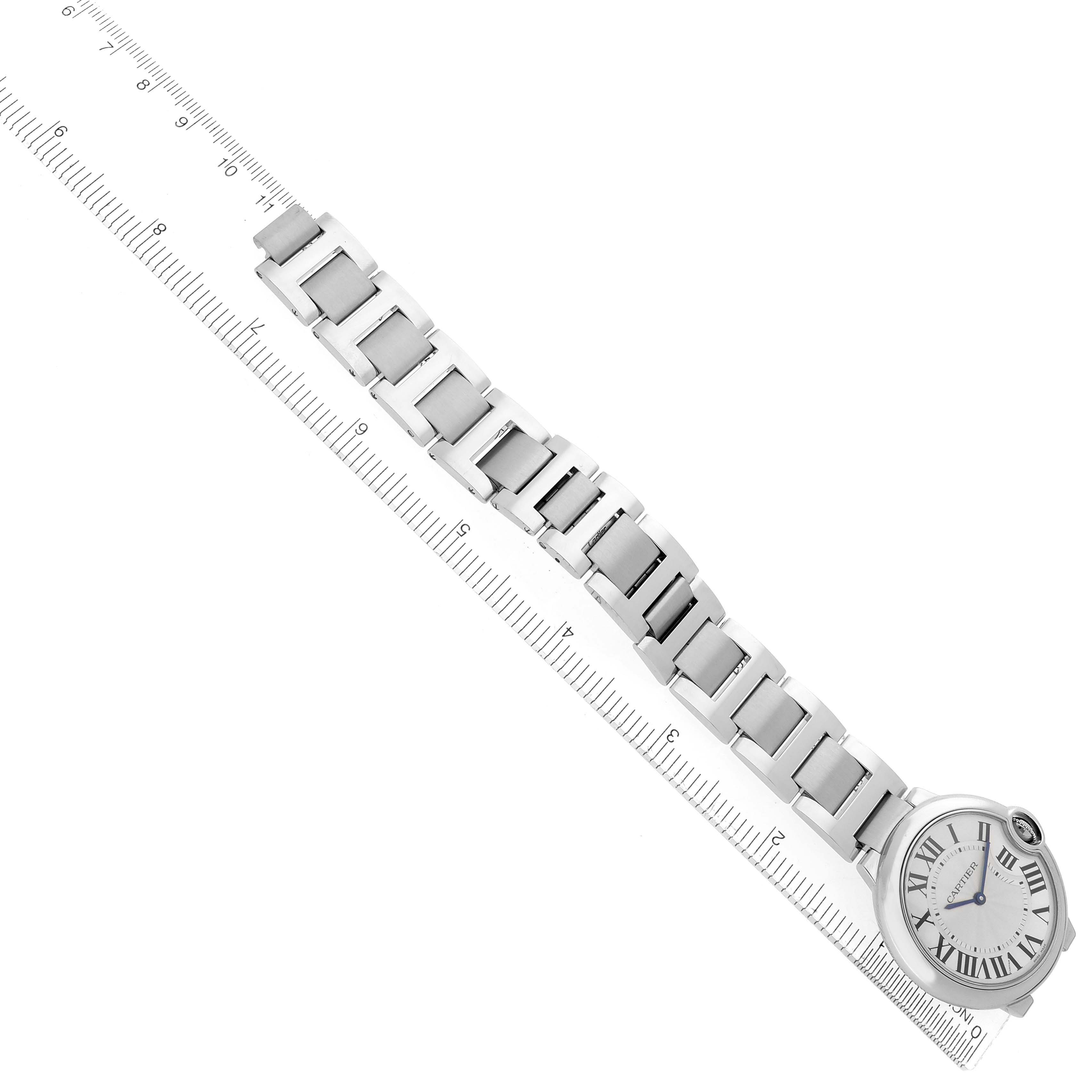 The Cartier Ballon Bleu W69011Z4 Men
s Stainless Steel Silver Dial W69011Z4 Men
s Stainless Steel Silver Dial watch is shown at an angle displaying the face and full metal bracelet alongside a ruler.