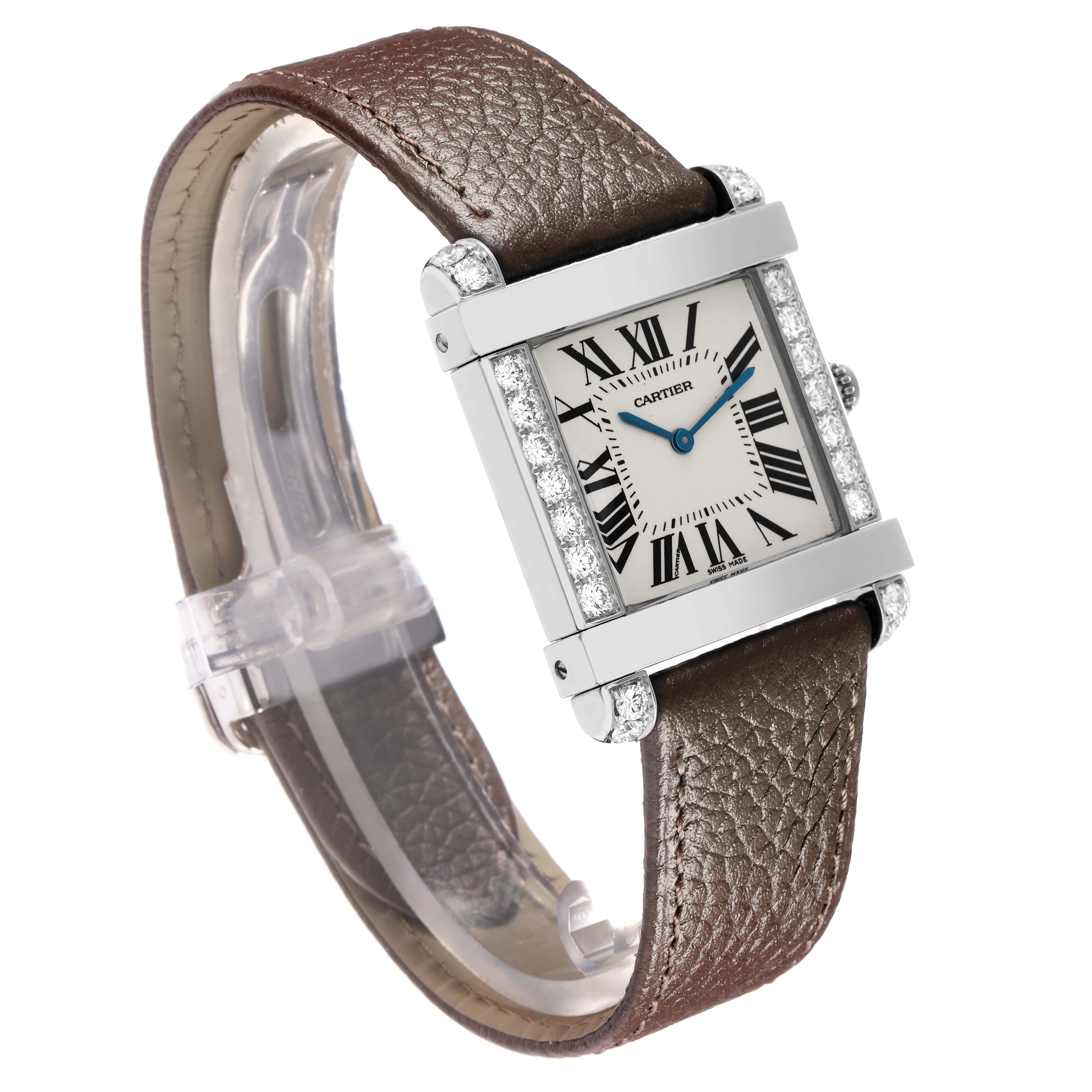 The Tank Louis model by Cartier is shown at an angled view, highlighting its leather strap, rectangular face, and diamond accents.