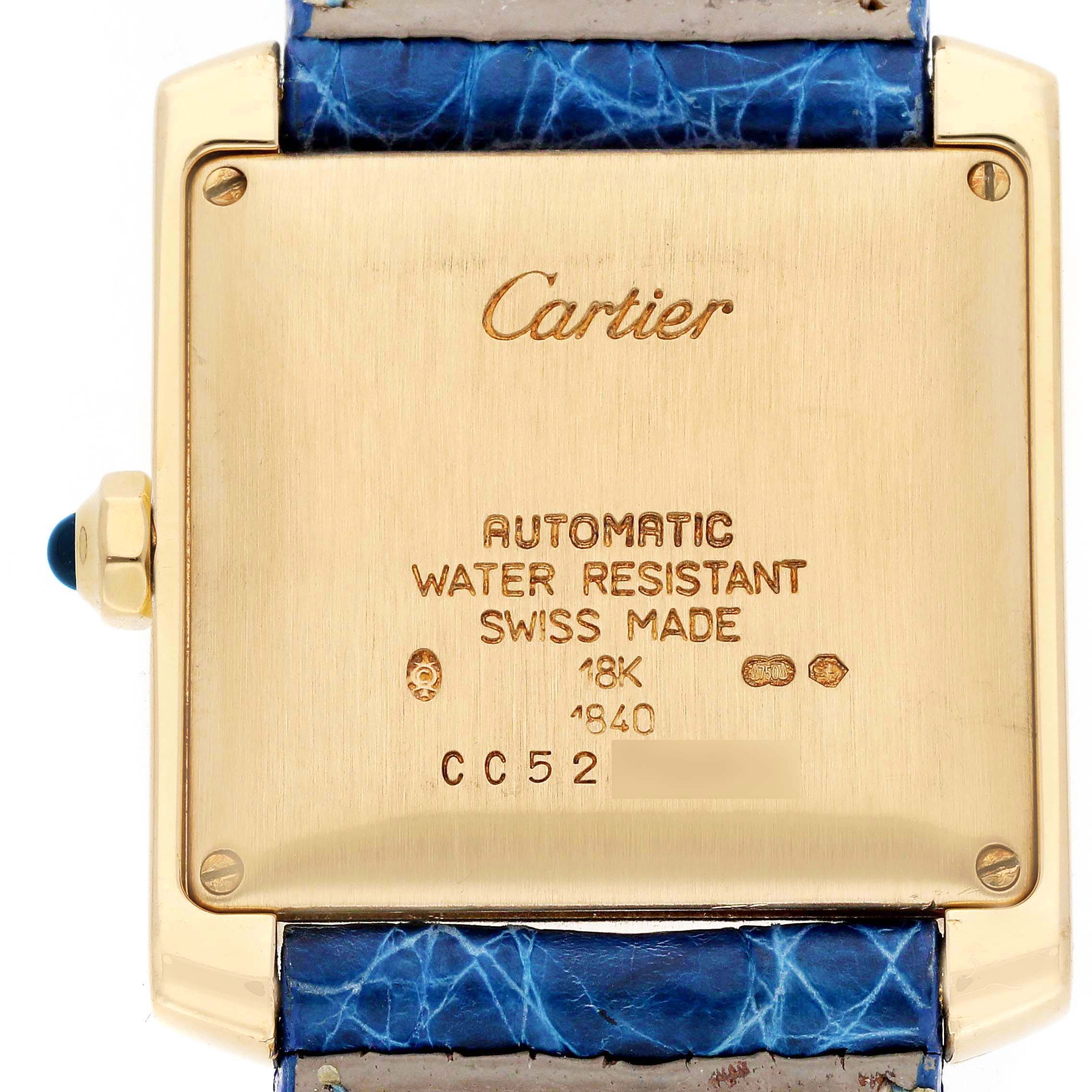 The image shows the back of a Cartier Tank Francaise W5000156 Men
s Yellow Gold Silver Dial W5000156 Men
s Yellow Gold Silver Dial watch, highlighting its inscriptions and blue strap.