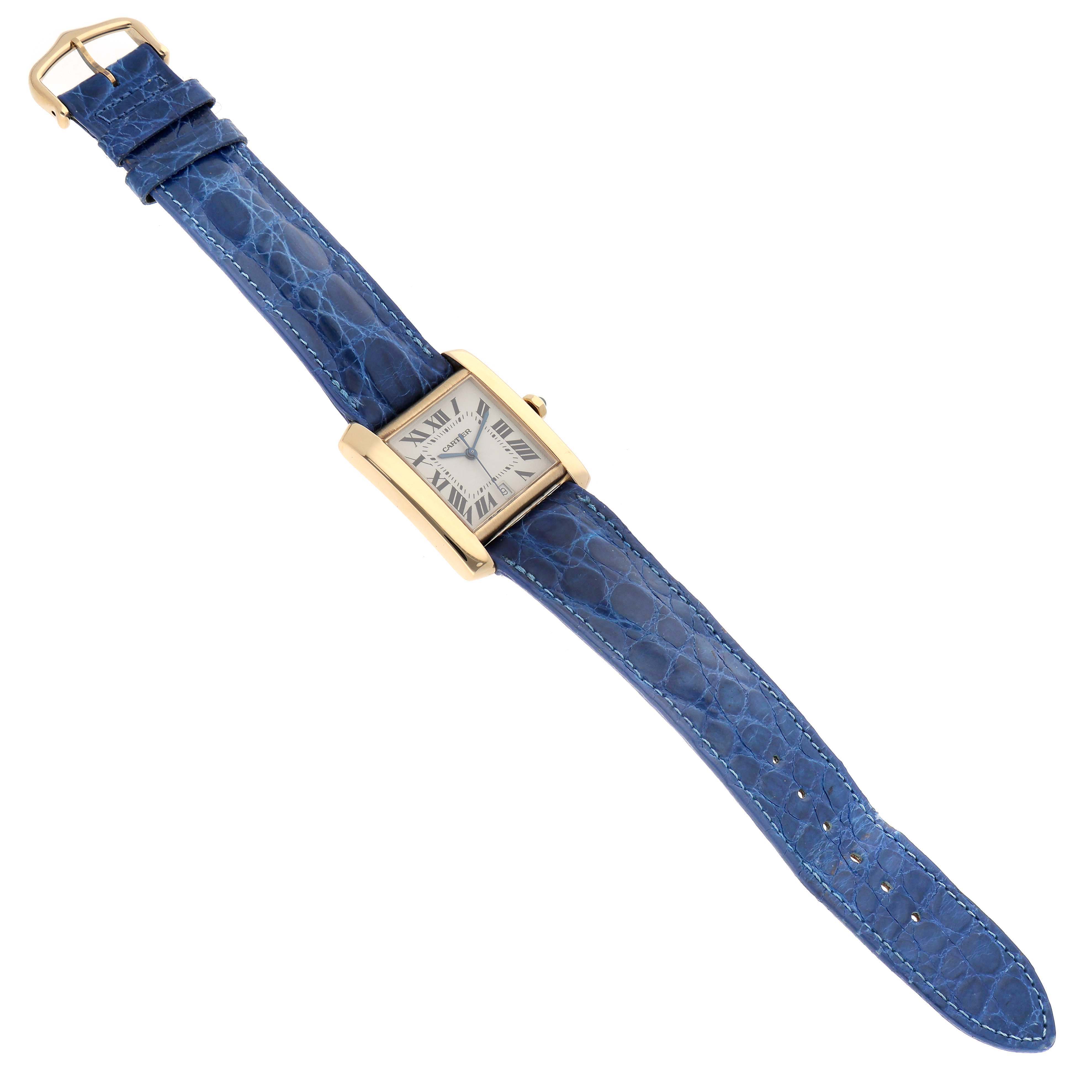 This image shows a Cartier Tank Française watch with a rectangular face and blue leather strap, positioned flat and fully extended.