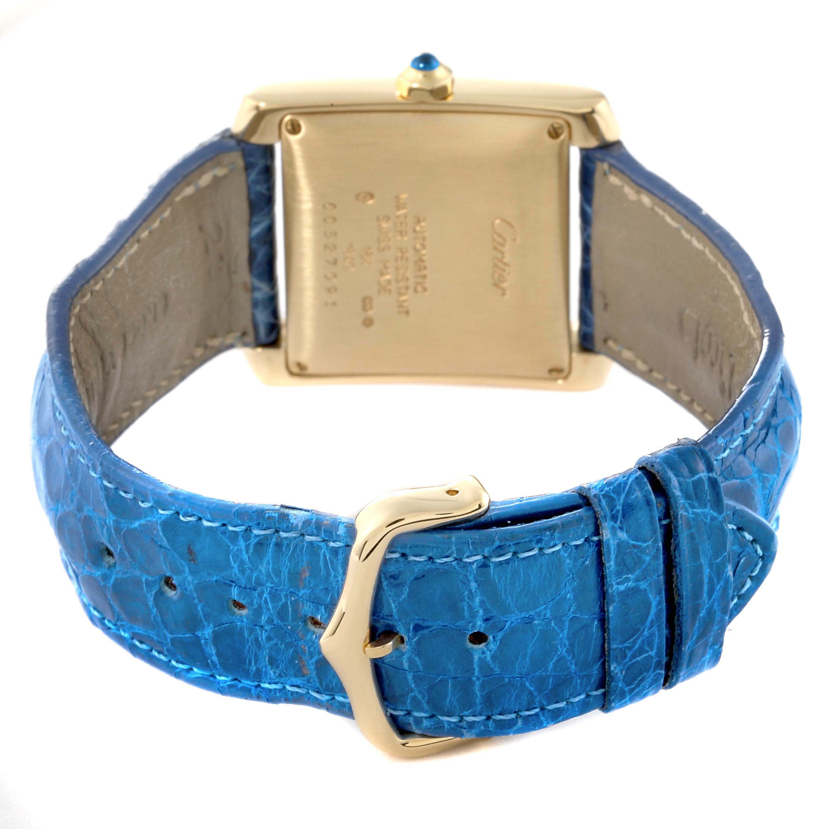 The image shows the back view of a Cartier Tank Française watch with a blue leather strap and gold buckle.