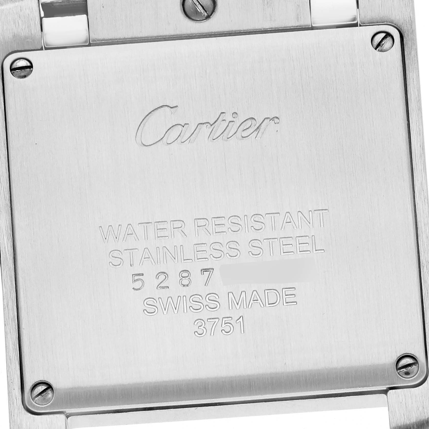 The image shows the back case of the Cartier Tank Française watch, displaying engravings and screws.