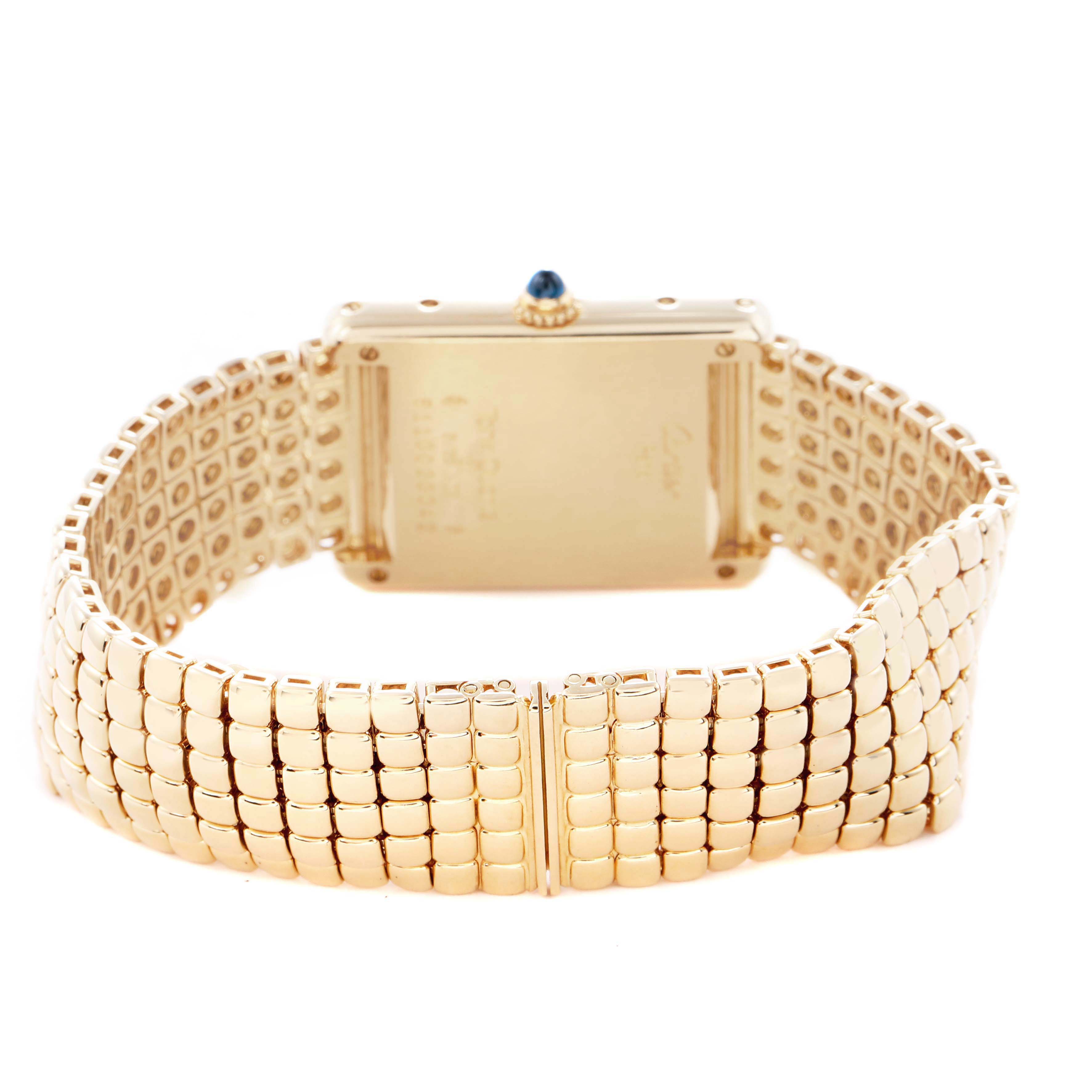 The image shows the back view of the Tank Louis watch by Cartier, highlighting its gold case and bracelet.