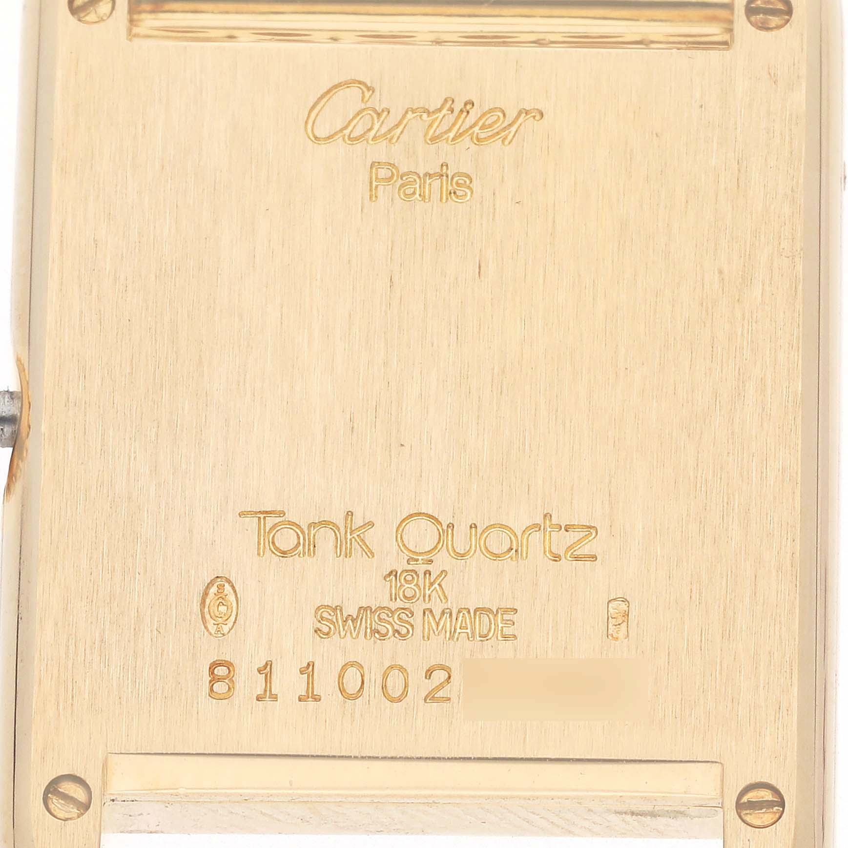 The image shows the back of a Cartier Tank Louis 8110 Women
s Yellow Gold White Dial 8110 Women
s Yellow Gold White Dial watch, displaying engravings and serial information.