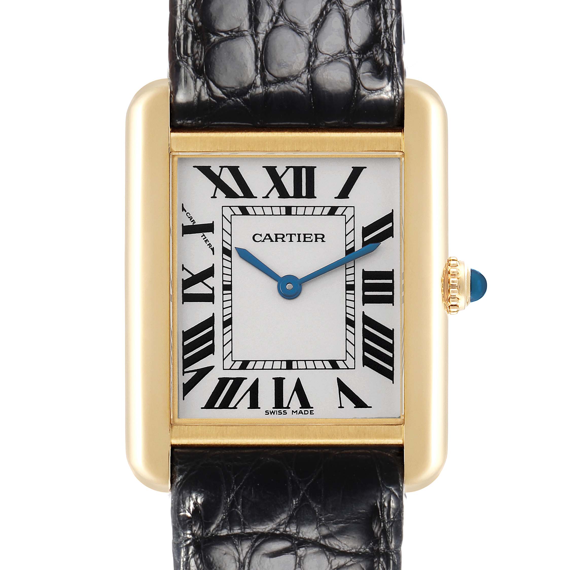 The Cartier Tank Solo W1018755 Women
s Yellow Gold Silver Dial W1018755 Women
s Yellow Gold Silver Dial watch is shown from a front angle, featuring the dial, Roman numerals, and crown with a blue stone.