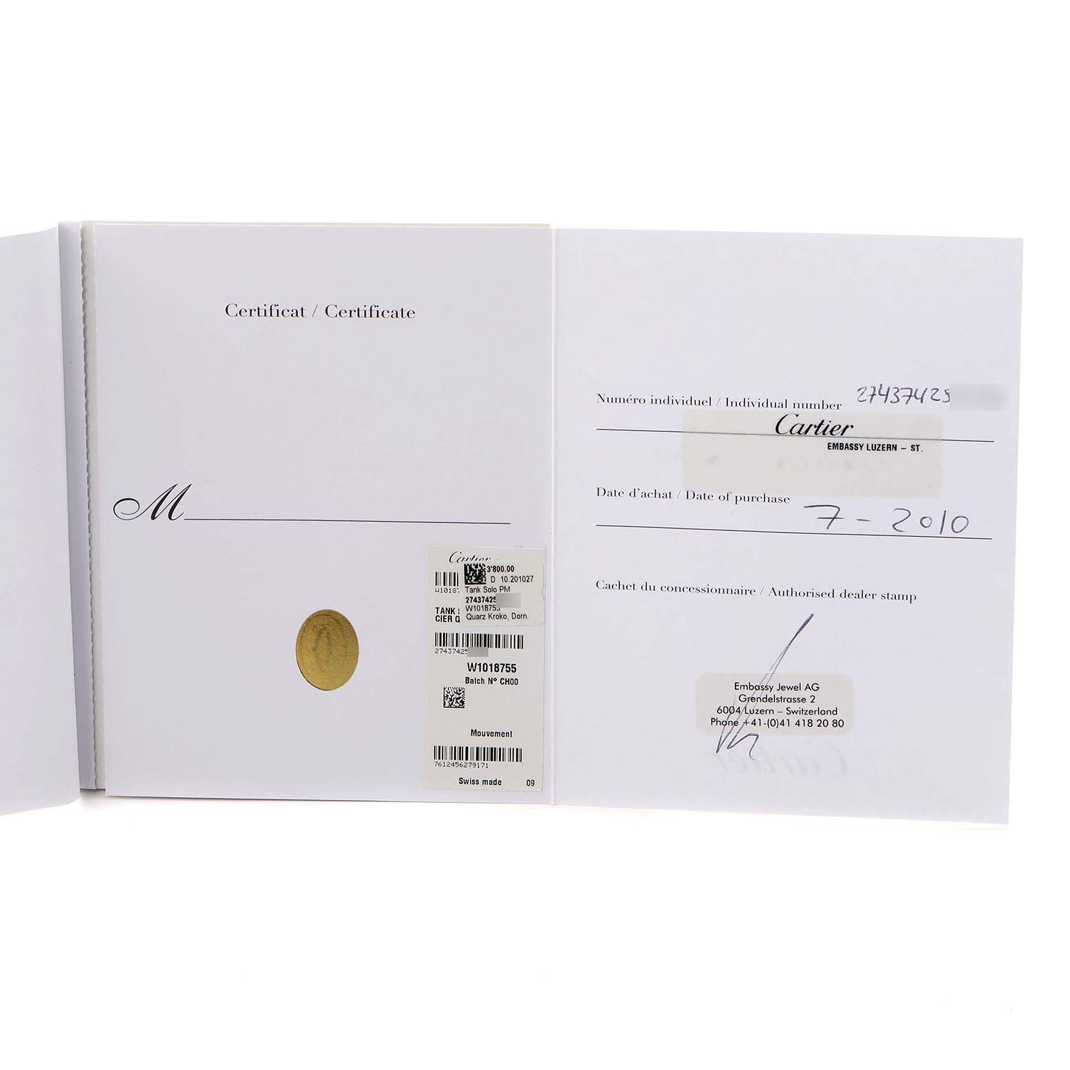 The image shows the certificate and warranty papers for the Cartier Tank Solo W1018755 Women
s Yellow Gold Silver Dial W1018755 Women
s Yellow Gold Silver Dial model.