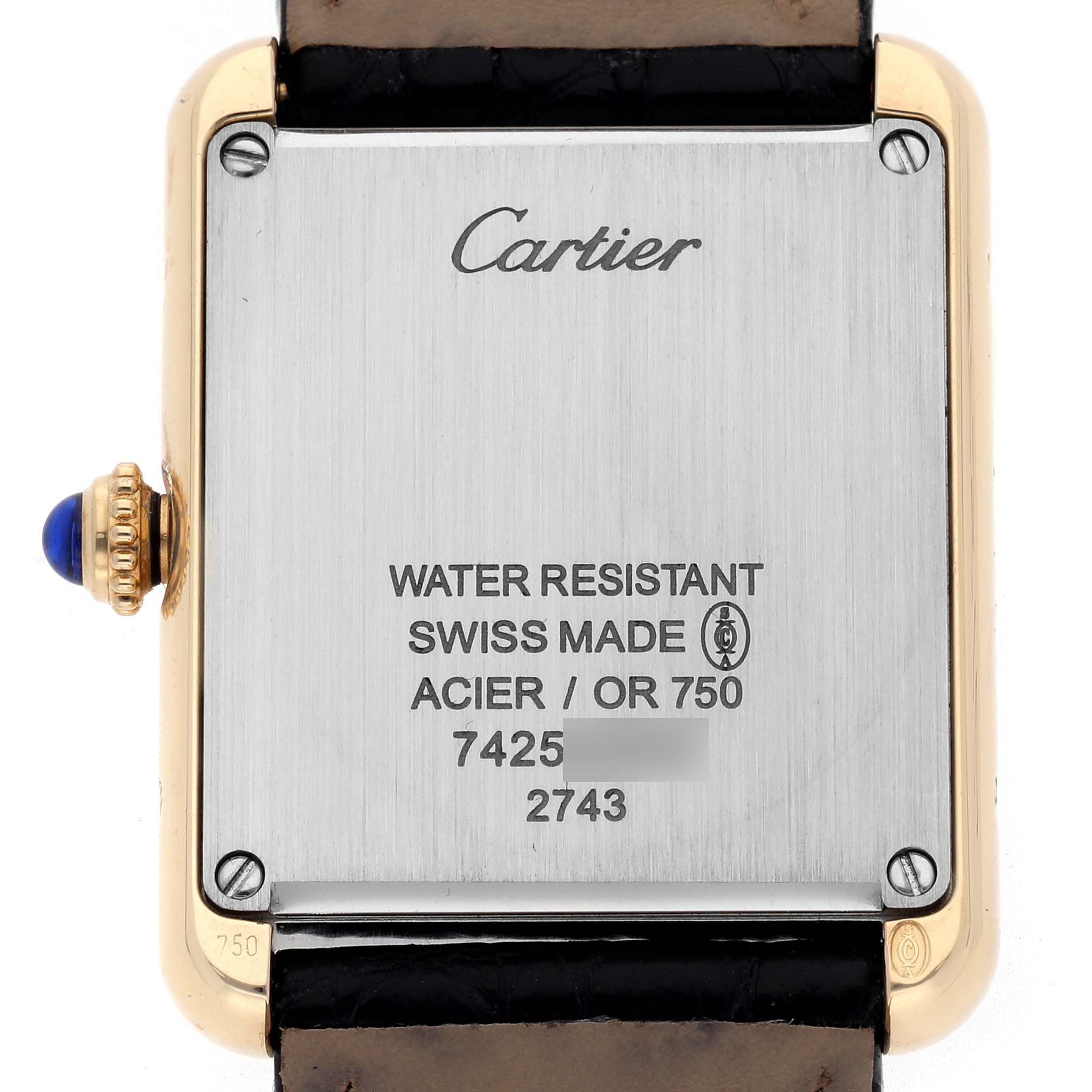 The image shows the back of a Cartier Tank Solo W1018755 Women
s Yellow Gold Silver Dial W1018755 Women
s Yellow Gold Silver Dial watch, highlighting its case back engravings and crown.