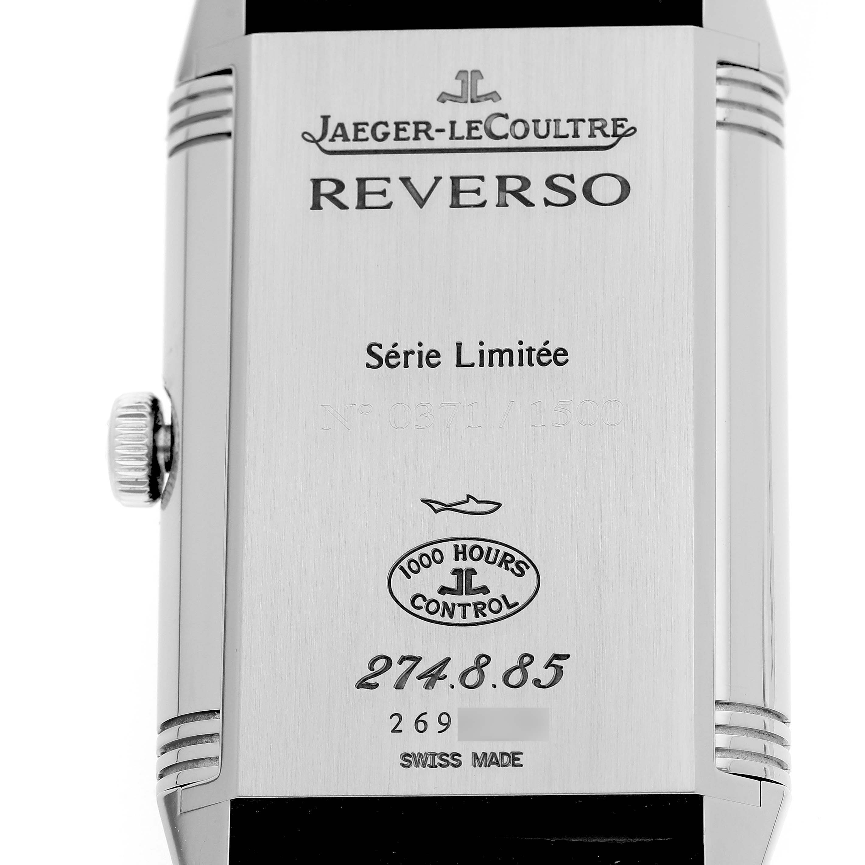 The image shows the back of a Jaeger-LeCoultre Reverso watch, displaying its engravings and serial information.