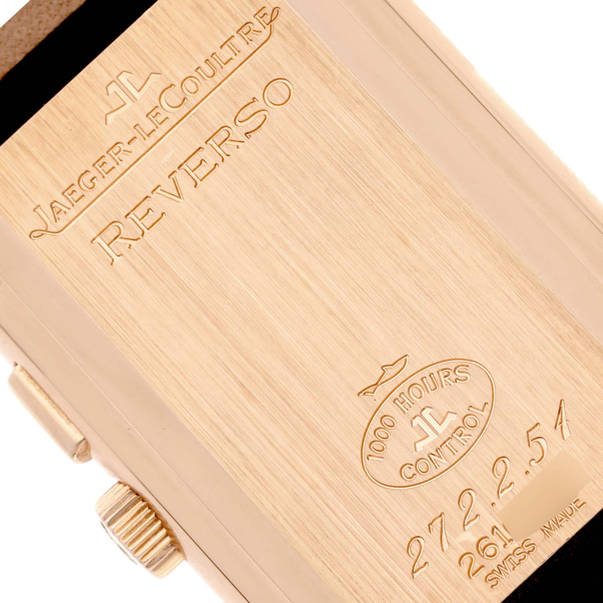 The image shows the engraved back plate and crown of a Jaeger-LeCoultre Reverso watch.