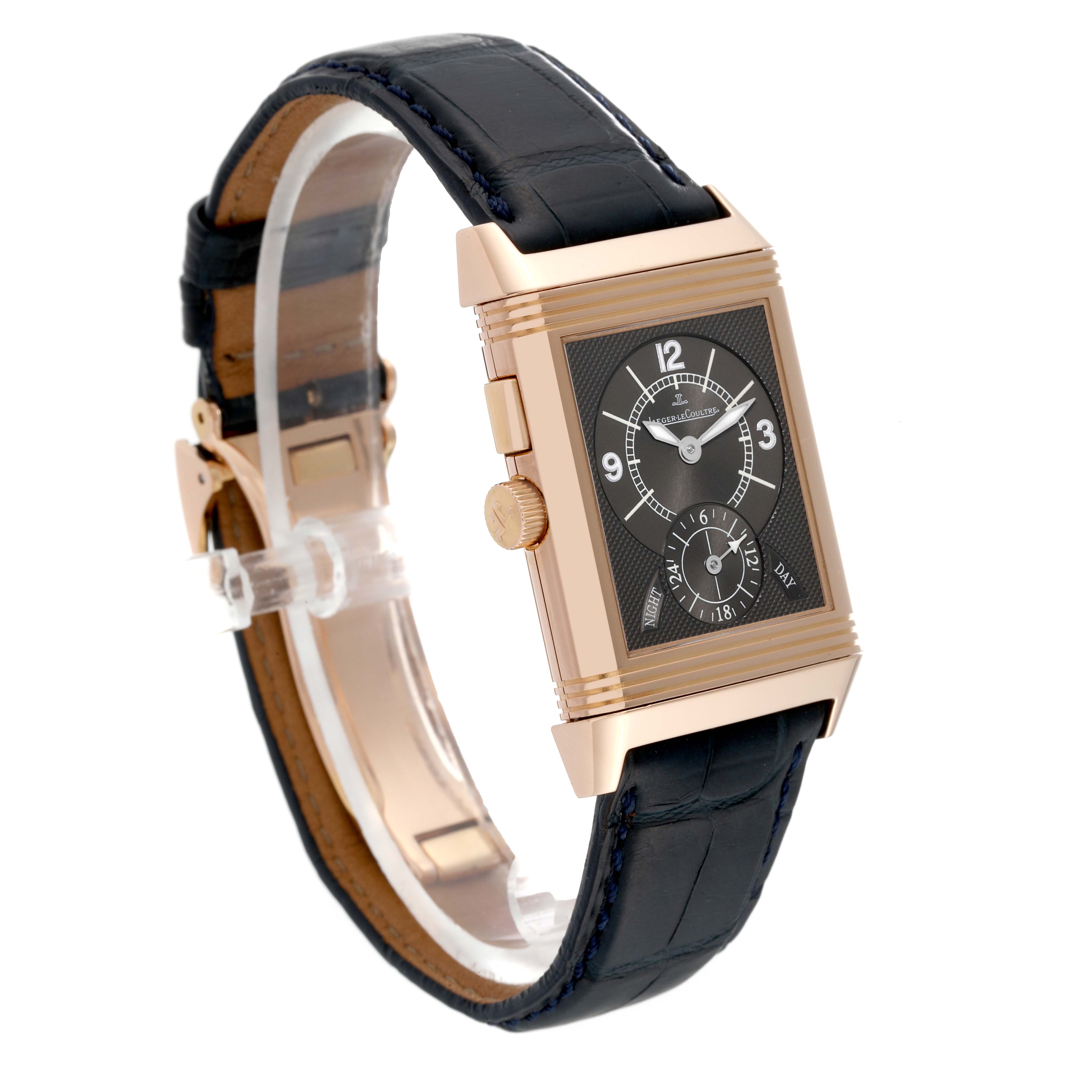 This image shows a Jaeger LeCoultre Reverso Q2712411 Men's Rose Gold Silver Dial Q2712411 Men's Rose Gold Silver Dial watch at a slight angle, featuring its rectangular face, crown, and leather strap.