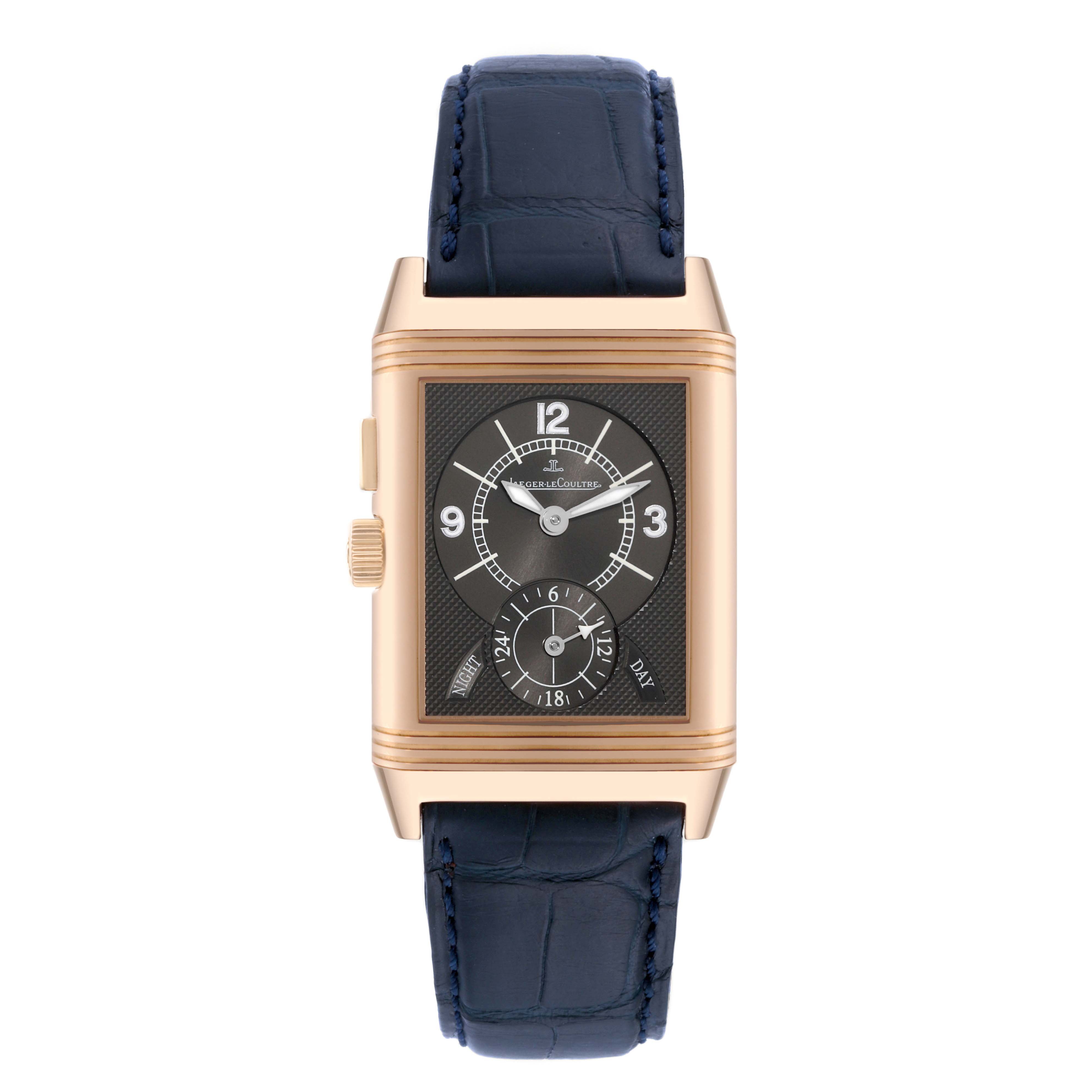 The image shows a Jaeger LeCoultre Reverso Q2712411 Men's Rose Gold Silver Dial Q2712411 Men's Rose Gold Silver Dial watch from a front angle, highlighting its rectangular face, gold case, and blue leather strap.