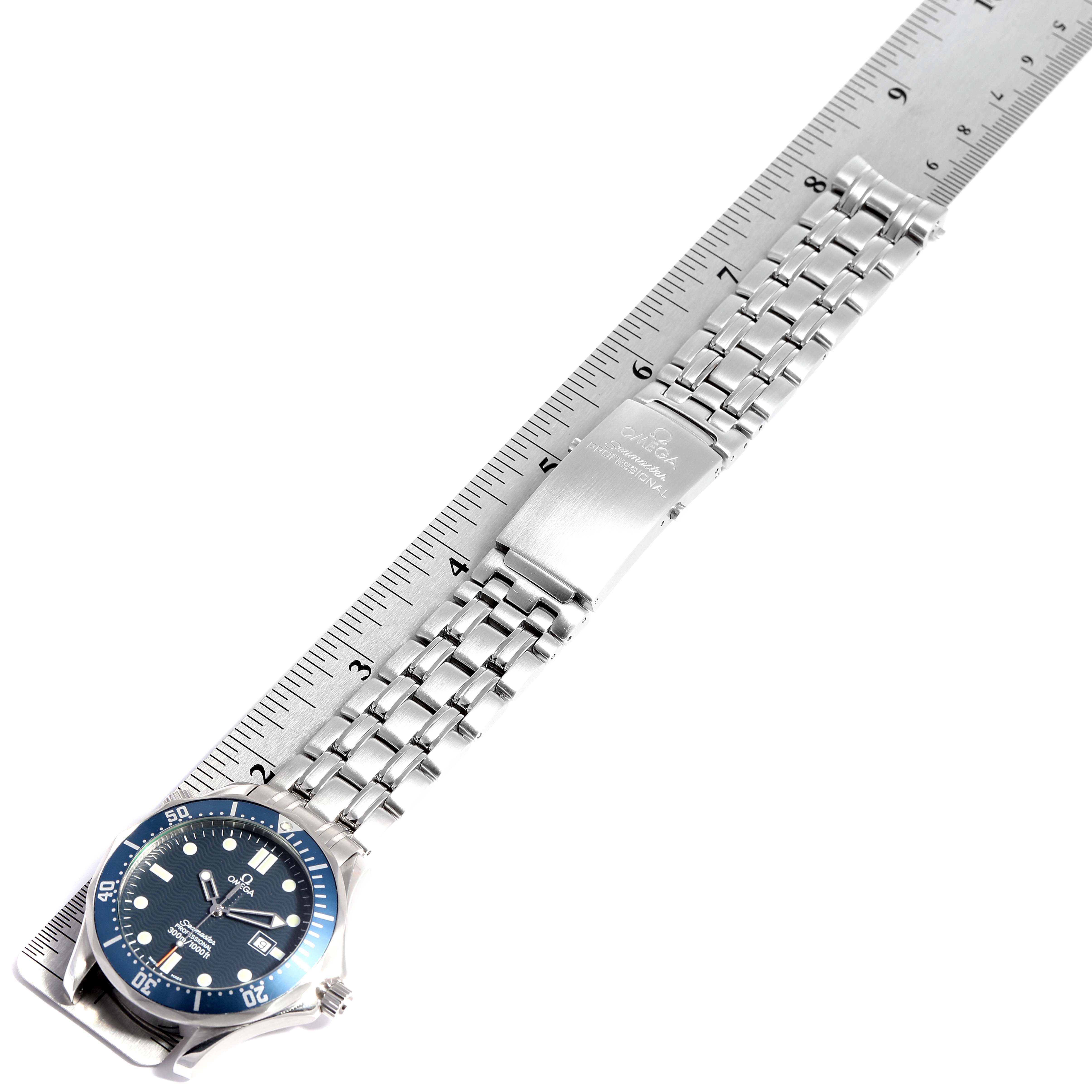 The image shows an Omega Seamaster 2541.80.00 Men
s Stainless Steel Blue Dial 2541.80.00 Men
s Stainless Steel Blue Dial watch laid flat with a stainless steel bracelet and clasp, alongside a ruler for scale.