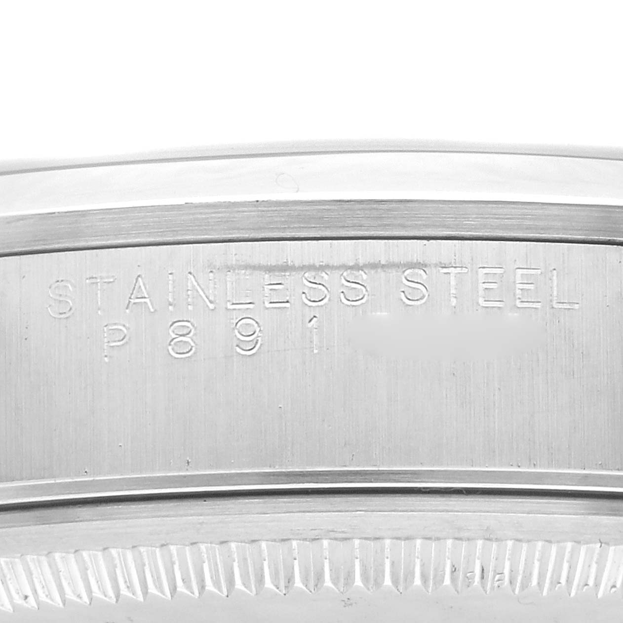 The image shows a close-up of the stainless steel case back of the Rolex Air-King 14000M Men's Stainless Steel Pink Dial 14000M Men's Stainless Steel Pink Dial watch, displaying the engraving.