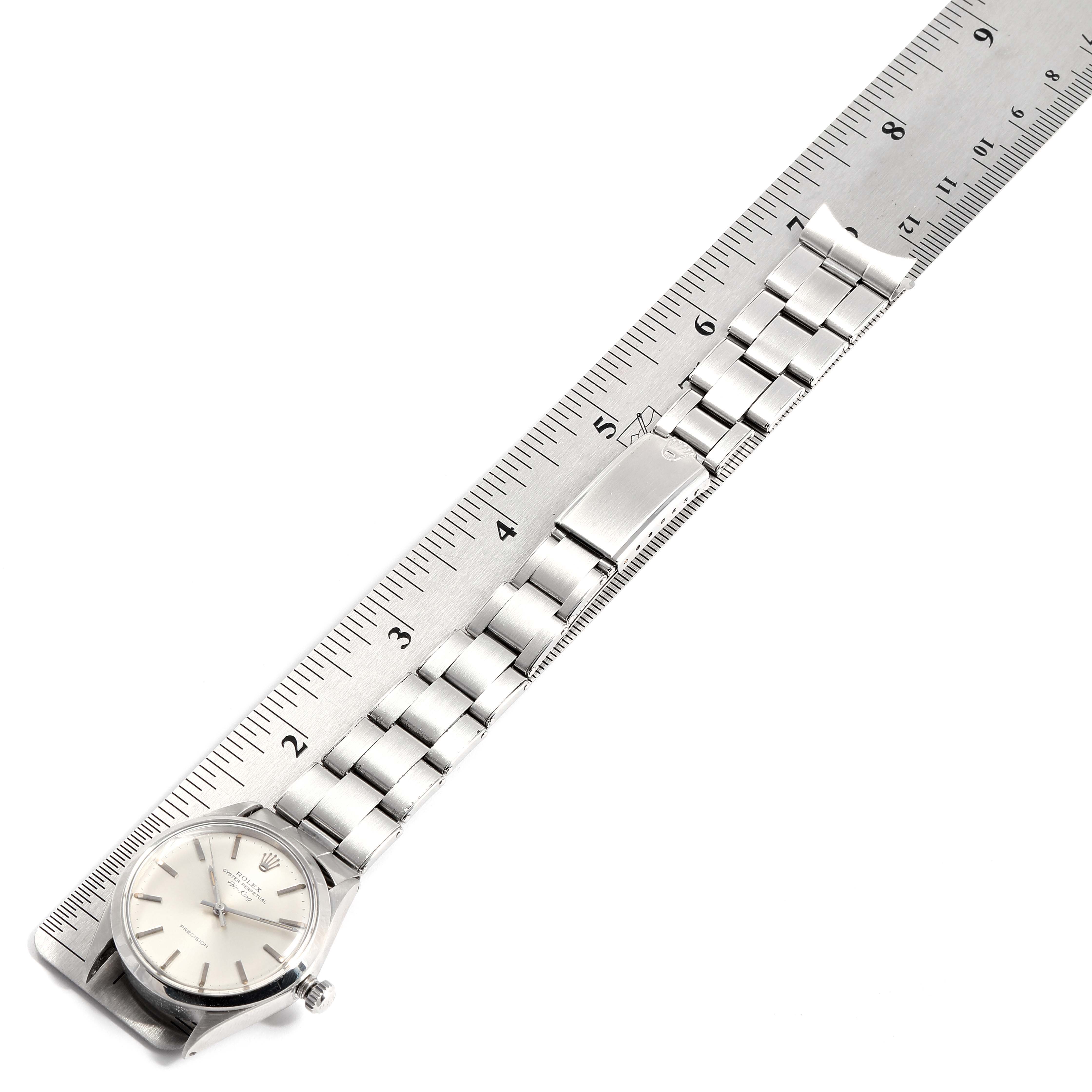 The image shows the face and stainless steel bracelet of a Rolex Vintage Collection 5500 Men
s Stainless Steel Silver Dial 5500 Men
s Stainless Steel Silver Dial watch against a measuring ruler.