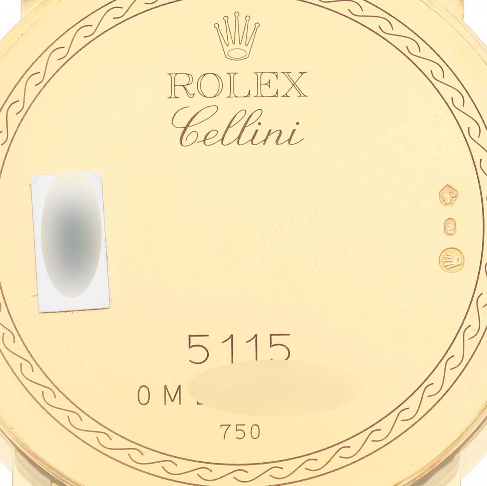 The image shows the back case engraving of a Rolex Cellini 5115 Men's Yellow Gold Grey Dial 5115 Men's Yellow Gold Grey Dial model, featuring the brand logo, model number, and hallmark symbols.