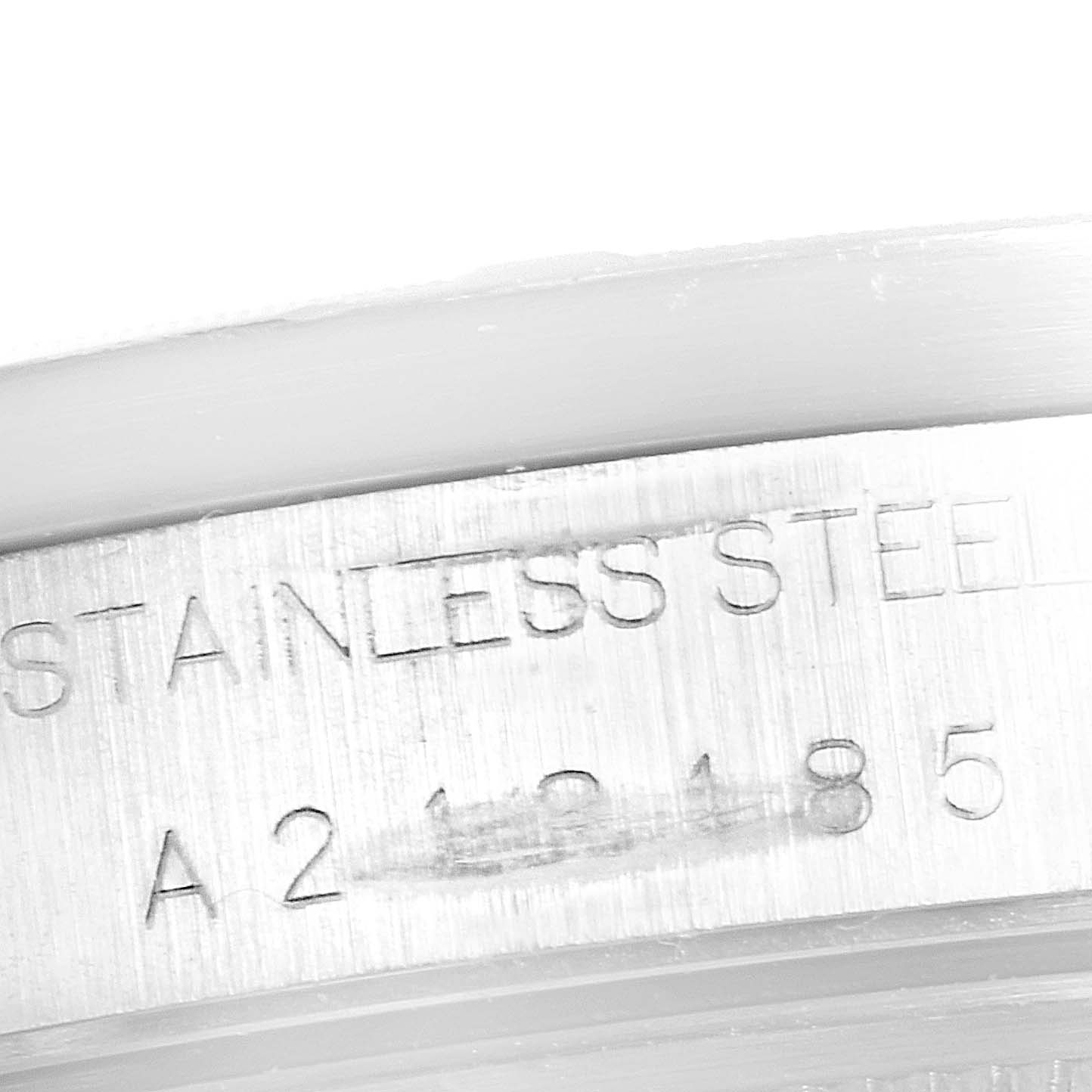 This image shows a close-up of the serial number and "STAINLESS STEEL" text engraved on the case of a Rolex Date 15210 Men's Stainless Steel Blue Dial 15210 Men's Stainless Steel Blue Dial model watch.