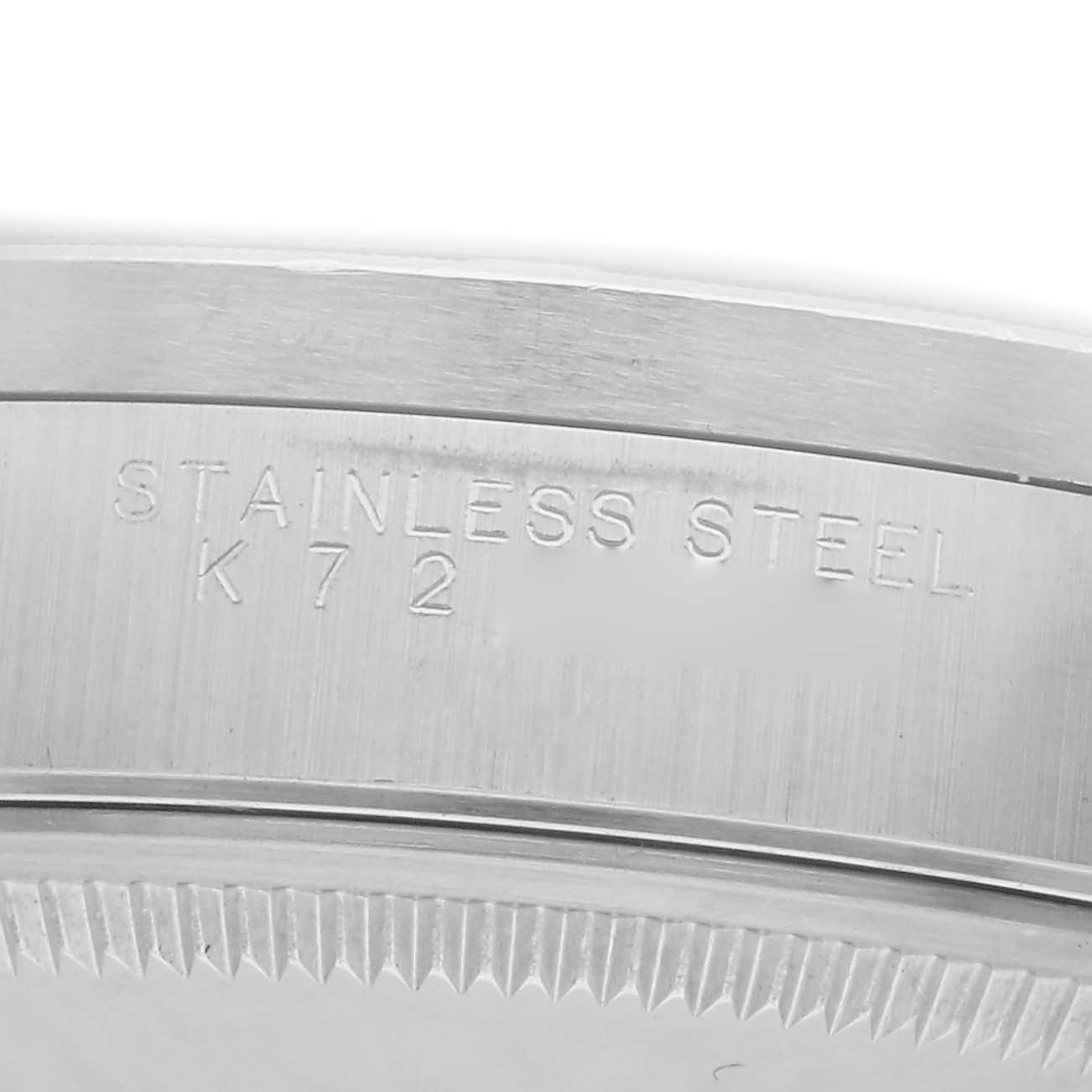The image shows a close-up of the stainless steel side and rim of a Rolex Date 15210 Men
s Stainless Steel Silver Dial model, highlighting the engraved text.