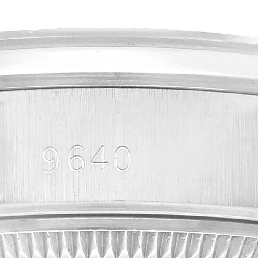 This image shows the side view of a Rolex Date 69160 Women
s Stainless Steel Silver Dial 69160 Women
s Stainless Steel Silver Dial model, focusing on the serial number engraving.
