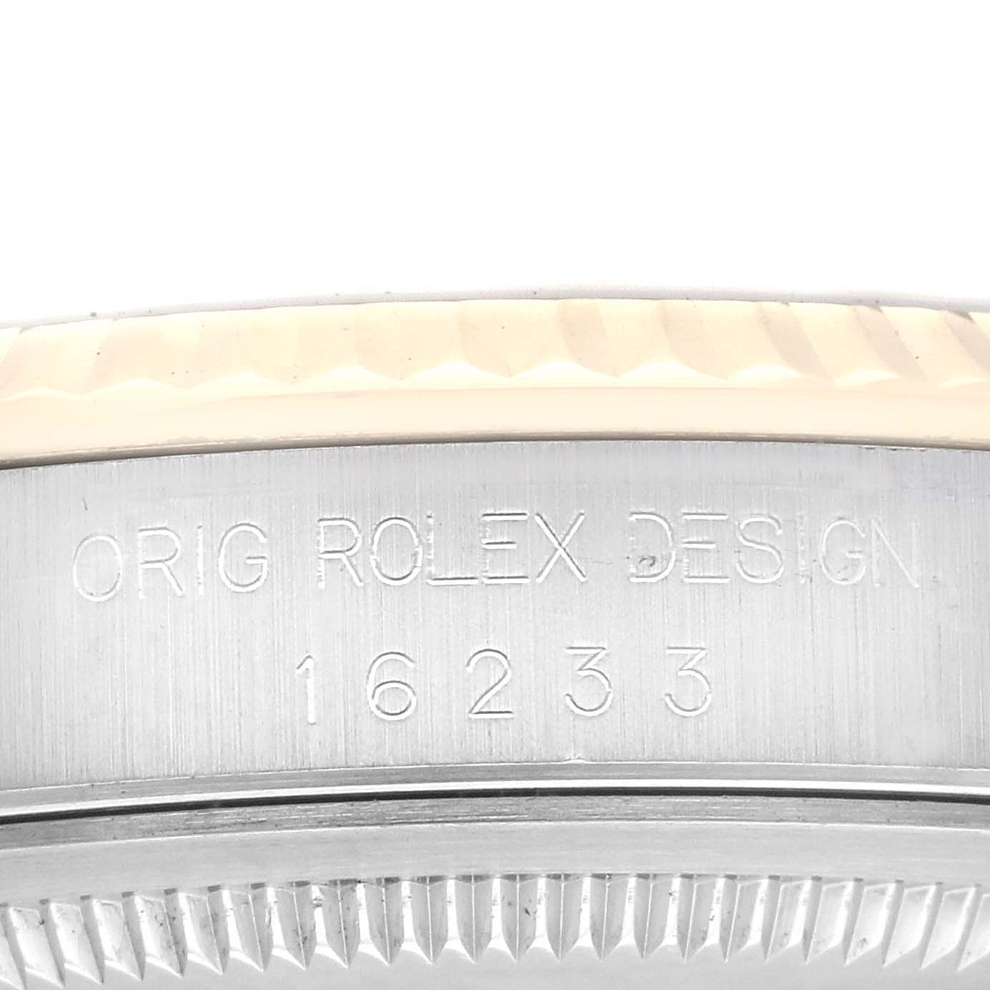 This image shows a close-up of the side casing of a Rolex Datejust 16233 Men's Steel and Gold (two tone) Black Dial 16233 Men's Steel and Gold (two tone) Black Dial watch, displaying the "ORIG ROLEX DESIGN 16233" engraving.