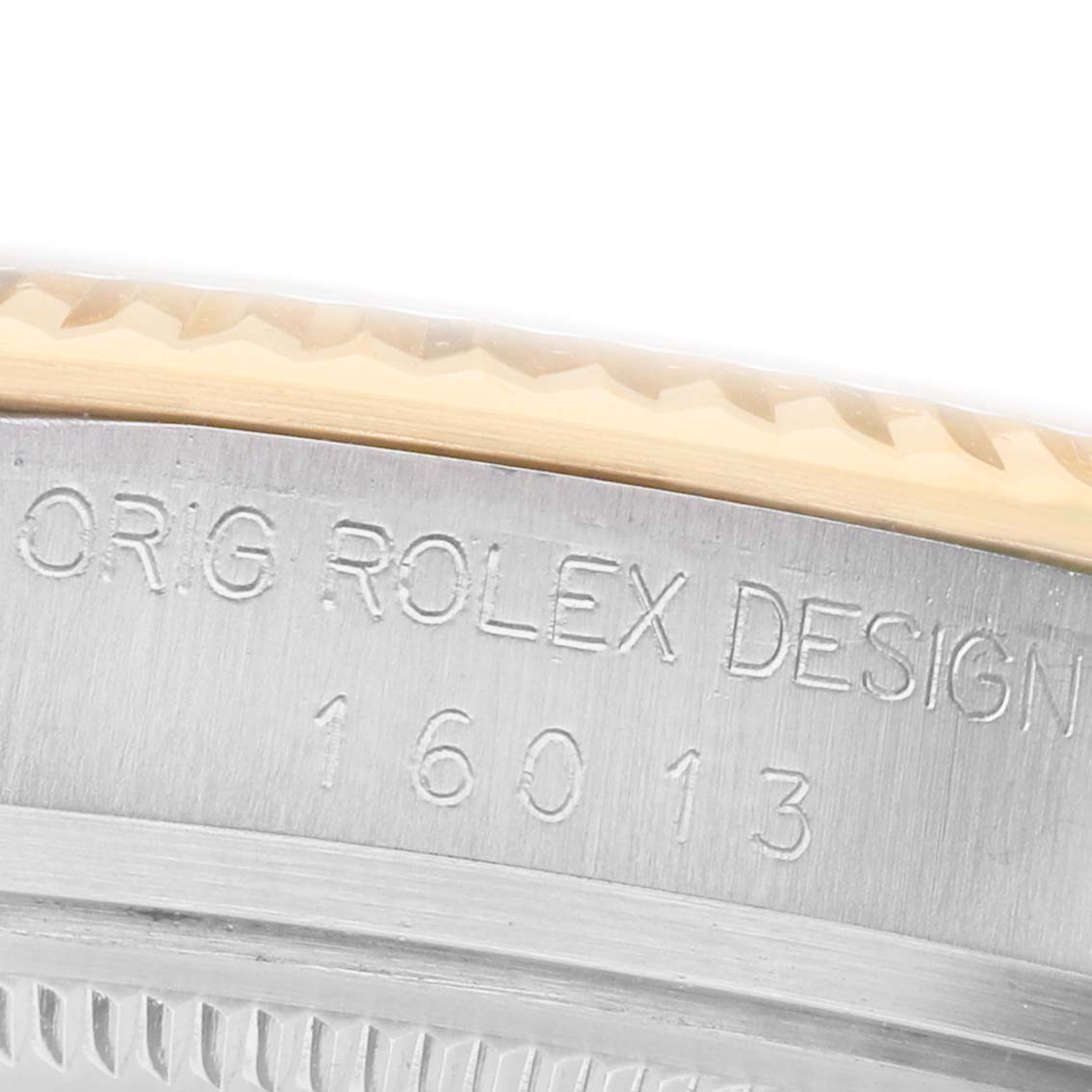 The image shows a close-up of the Rolex Datejust 16013 Men's Steel and Gold (two tone) Champagne Dial model, focusing on the side of the case with engraved text and the bezel edge.