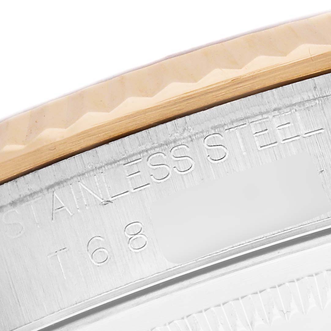 The image shows a close-up of the side of a Rolex Datejust 16233 Men
s Steel and Gold (two tone) Yellow Dial 16233 Men
s Steel and Gold (two tone) Yellow Dial, highlighting the stainless steel case and bezel edge.