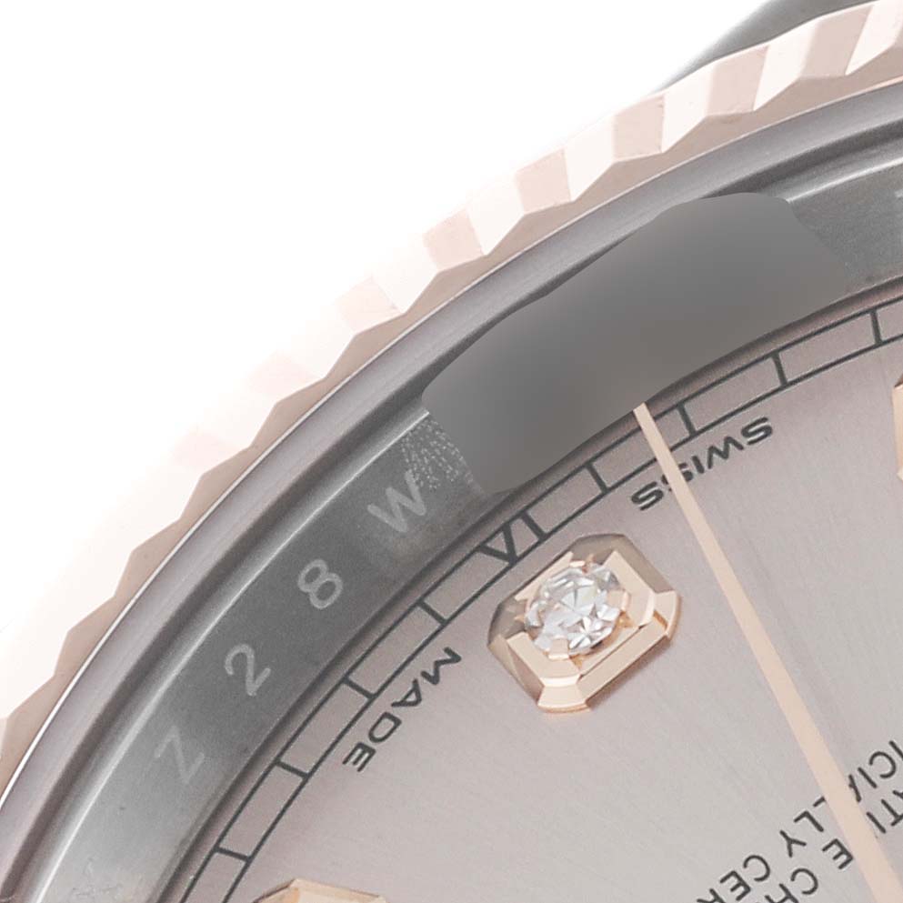 This close-up image of the Rolex Datejust 41 126331 Men's Steel and Gold (two tone) Pink Dial 126331 Men's Steel and Gold (two tone) Pink Dial watch shows part of the dial and the fluted bezel edge.