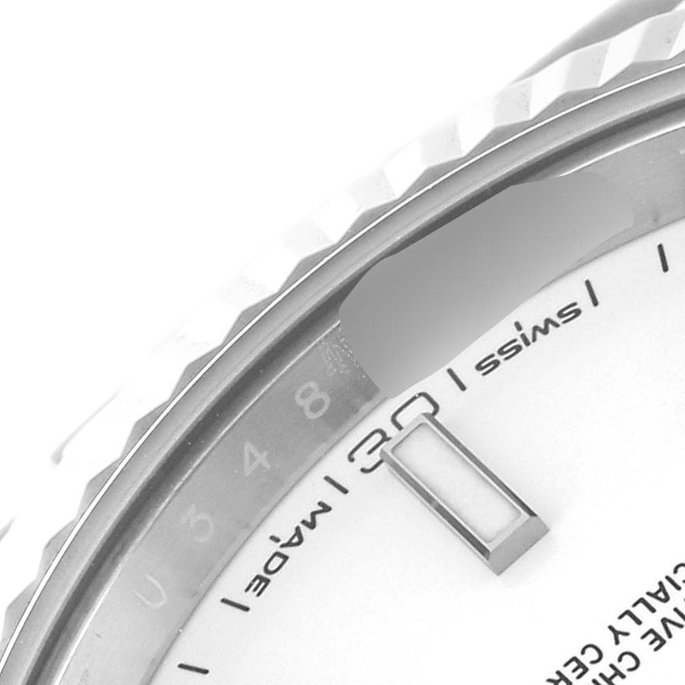 This image shows a close-up of the dial and fluted bezel of a Rolex Datejust 41 126334 Men's Stainless Steel White Dial 126334 Men's Stainless Steel White Dial watch.