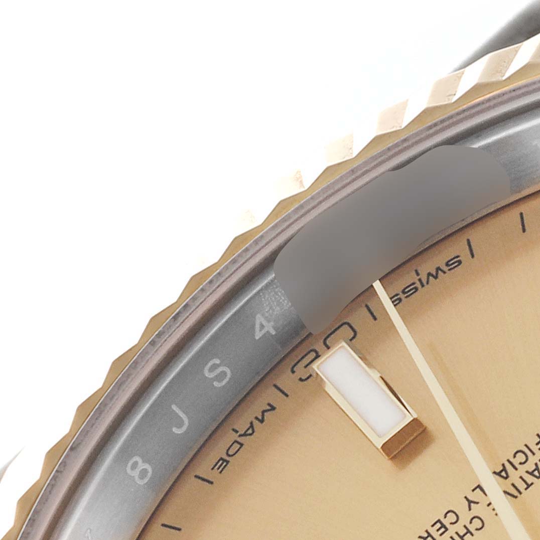 This image shows a close-up of the dial and fluted bezel of a Rolex Datejust 41 126333 Men's Steel and Gold (two tone) Champagne Dial 126333 Men's Steel and Gold (two tone) Champagne Dial watch, capturing the hour markers and "Swiss" inscription.