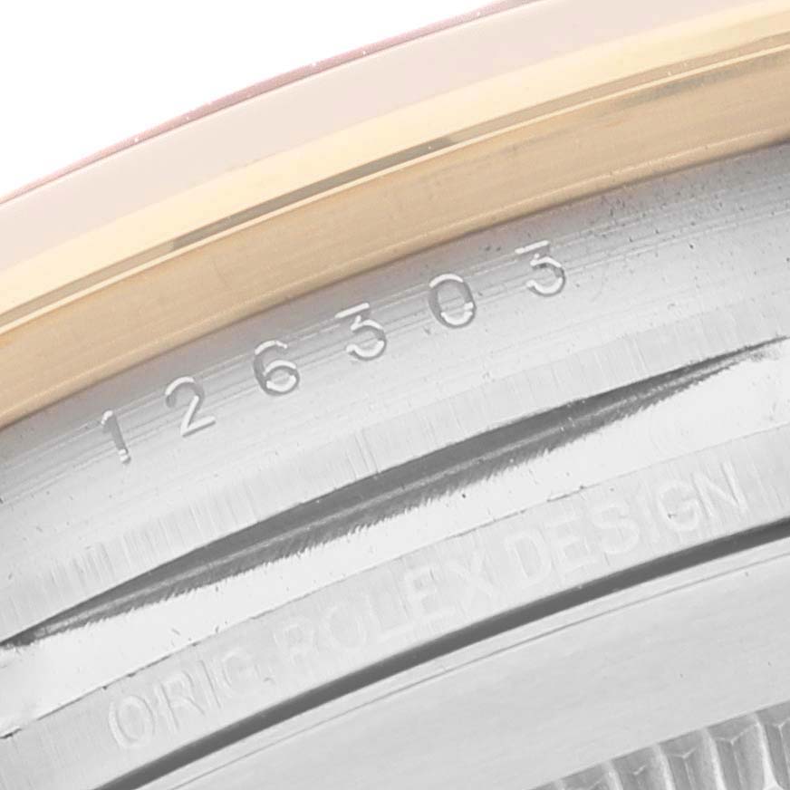 This image shows a close-up angle of the Rolex Datejust 41 126303 Men's Steel and Gold (two tone) Black Dial 126303 Men's Steel and Gold (two tone) Black Dial model showcasing its engraved serial number and part of the case.