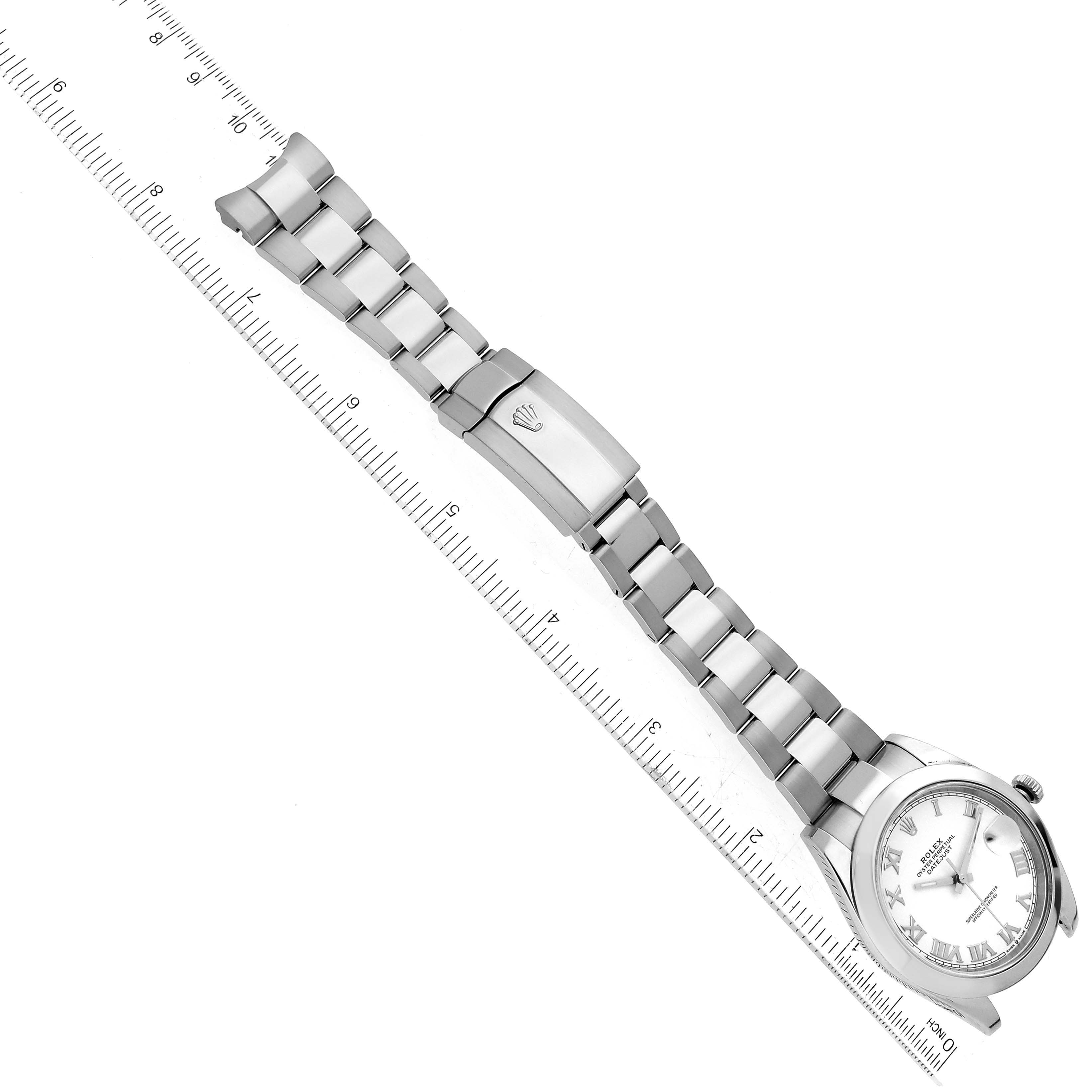 The Rolex Datejust 41 126300 Men's Stainless Steel White Dial 126300 Men's Stainless Steel White Dial watch is shown from a top-down angle, displaying the bracelet, clasp, case, and dial against a ruler.