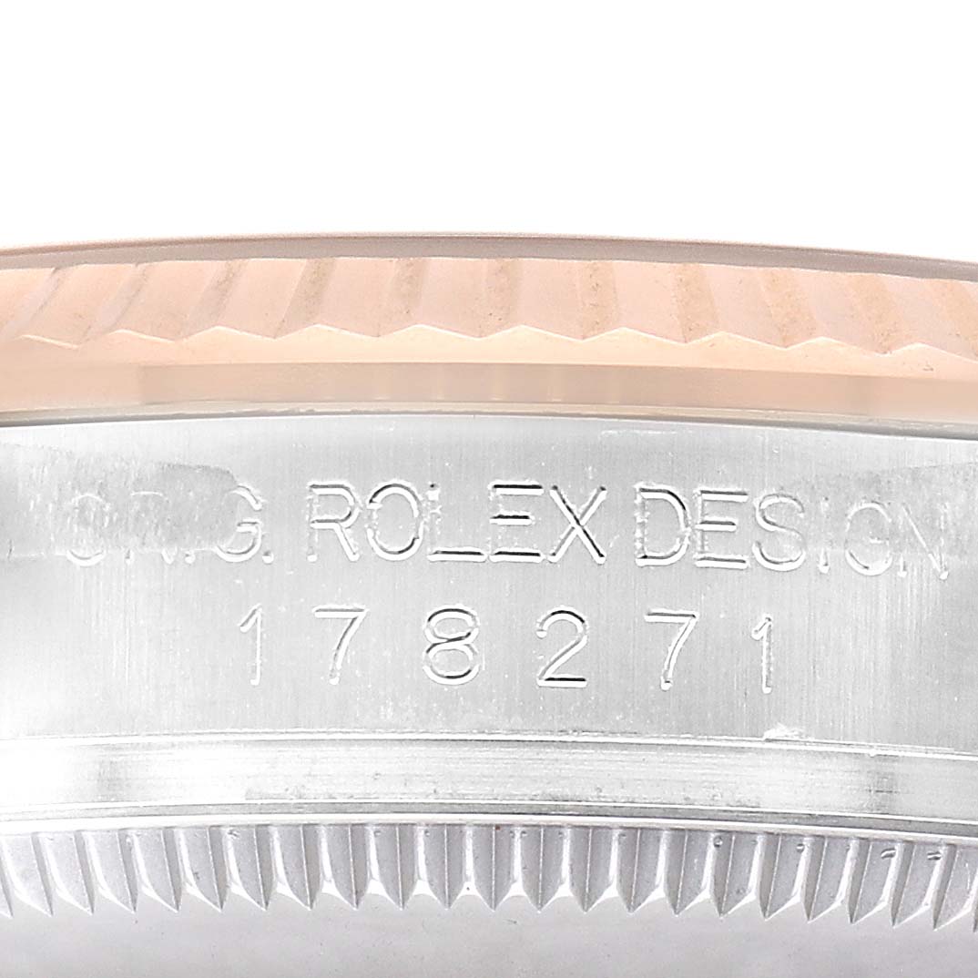 The image shows a close-up of the side engraving on the bezel of a Rolex Mid-Size 178271 Women's Stainless Steel Silver Dial watch, displaying "Rolex Design" and a model number.
