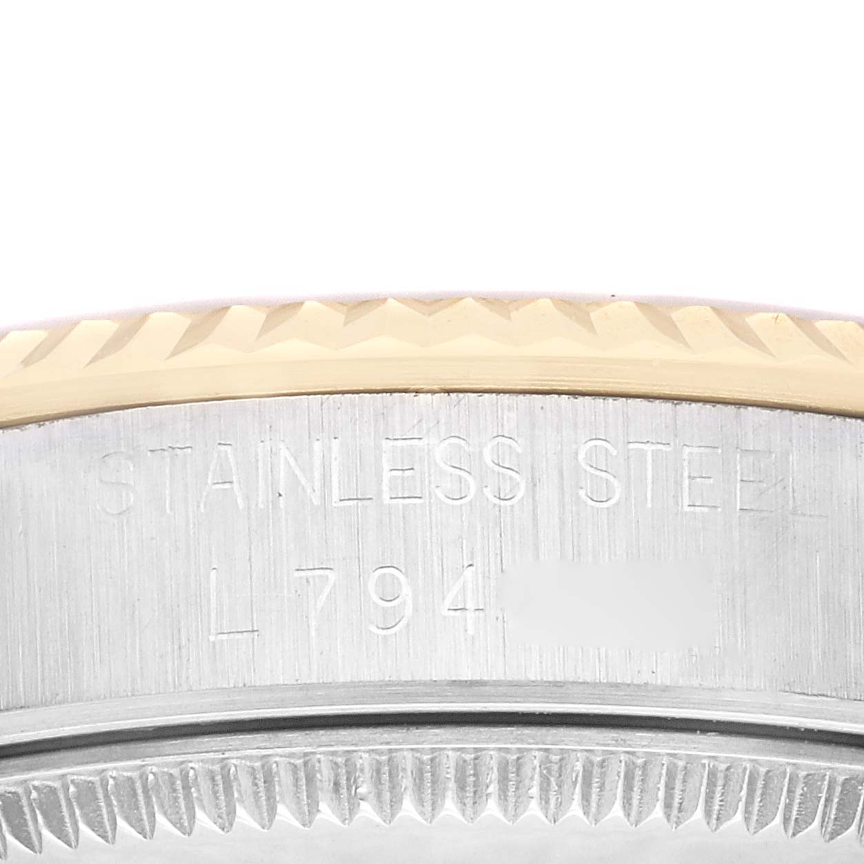 This is a close-up of the side case and bezel of a Rolex Mid-Size 68273 Women's Steel and Gold (two tone) Silver Dial 68273 Women's Steel and Gold (two tone) Silver Dial watch, showing the stainless steel material and serial number.
