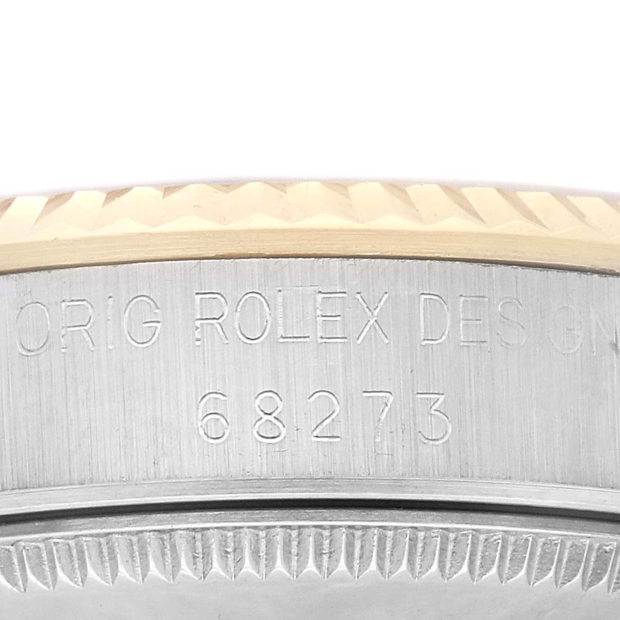 This image features a close-up of the engraving on the side of a Mid-Size Rolex watch case.