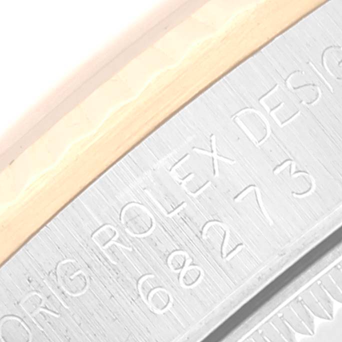 This close-up image shows part of the metal caseback with engraved text of a Rolex Mid-Size 68273 Women's Steel and Gold (two tone) Champagne Dial 68273 Women's Steel and Gold (two tone) Champagne Dial watch.