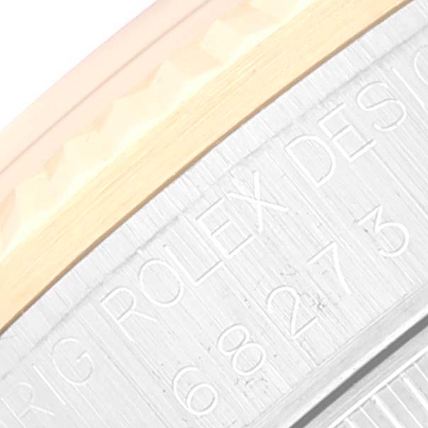 This image shows a close-up angle of the side engraving and part of the bezel of a Mid-Size Rolex watch.