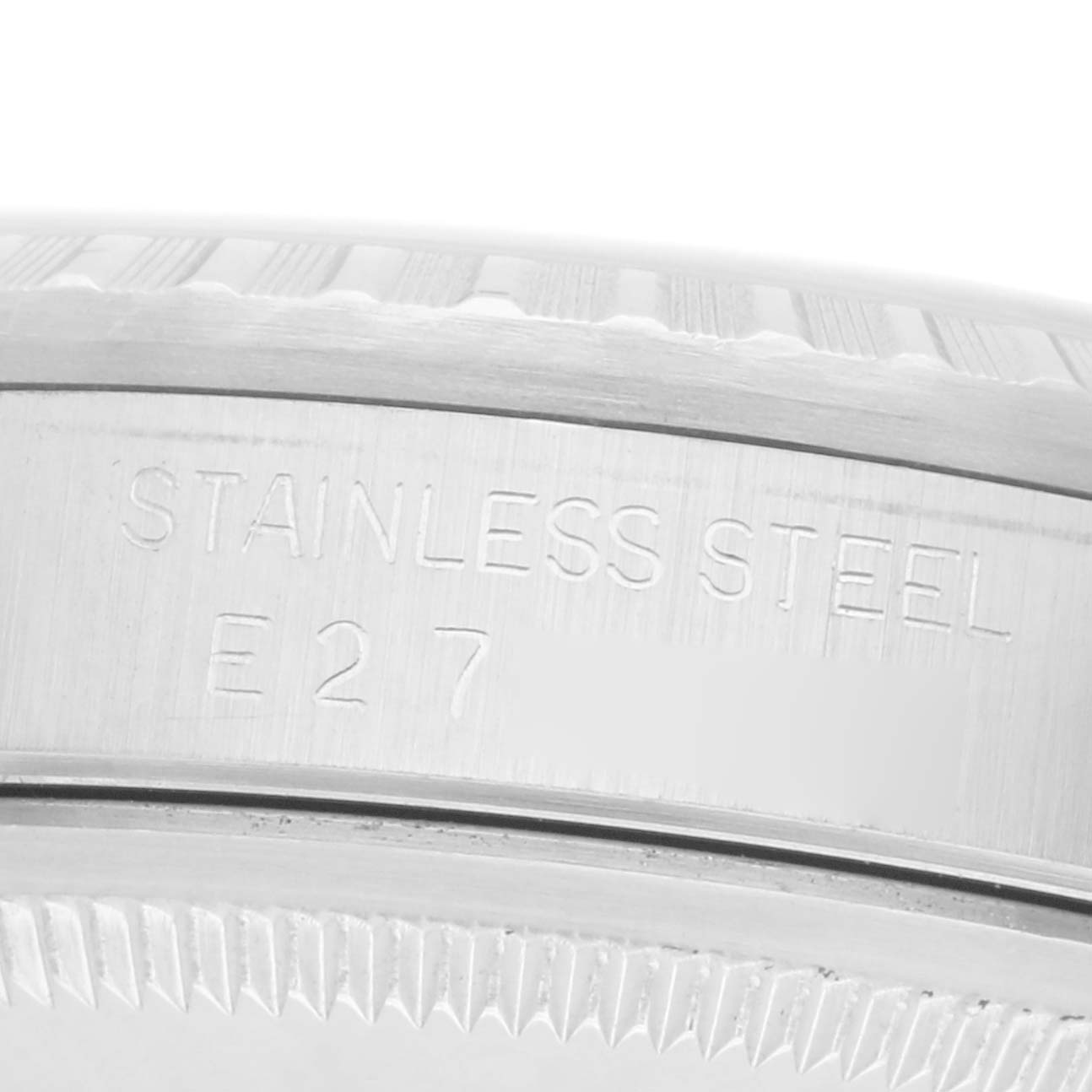 This close-up image shows the engraved side of the bezel of a Rolex Datejust 16220 Men
s Stainless Steel Silver Dial 16220 Men
s Stainless Steel Silver Dial, highlighting the "STAINLESS STEEL" text.