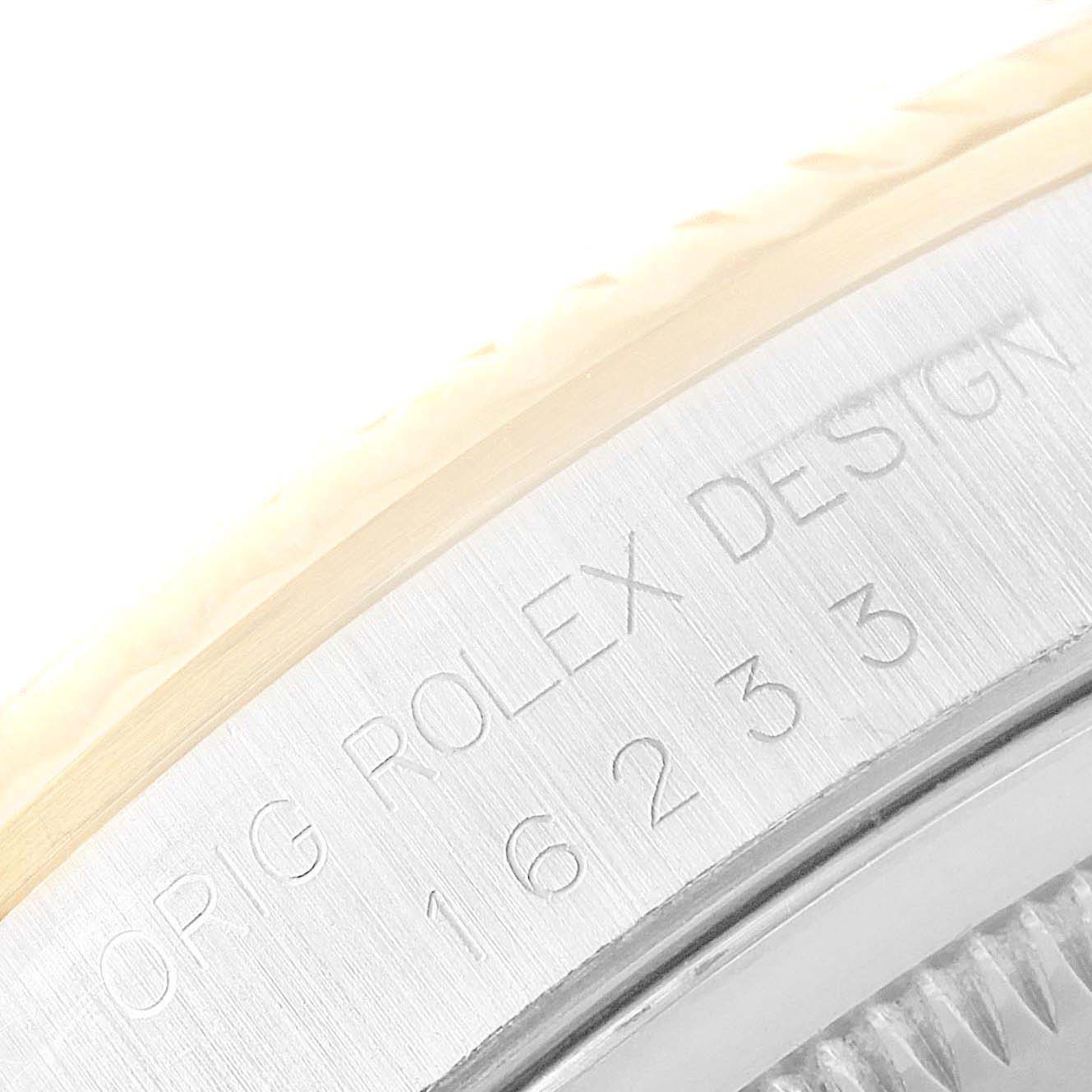 This image shows a close-up of the engraved bezel on a Rolex Datejust 16233 Men
s Steel and Gold (two tone) Champagne Dial 16233 Men
s Steel and Gold (two tone) Champagne Dial watch, focusing on the "ORIG ROLEX DESIGN" inscription.