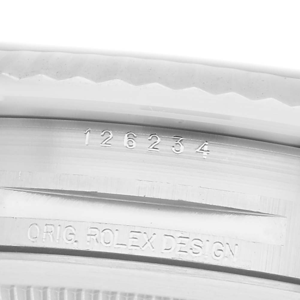 The image shows a close-up of the side of a Rolex Datejust 126234 Men
s Stainless Steel Blue Dial 126234 Men
s Stainless Steel Blue Dial, highlighting the model number and design engraving.