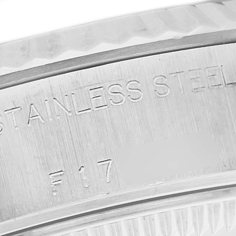 The image shows a close-up of the side of a Rolex Datejust 79174 Women
s Stainless Steel Mother of Pearl Dial 79174 Women
s Stainless Steel Mother of Pearl Dial watch, focusing on the stainless steel inscription.