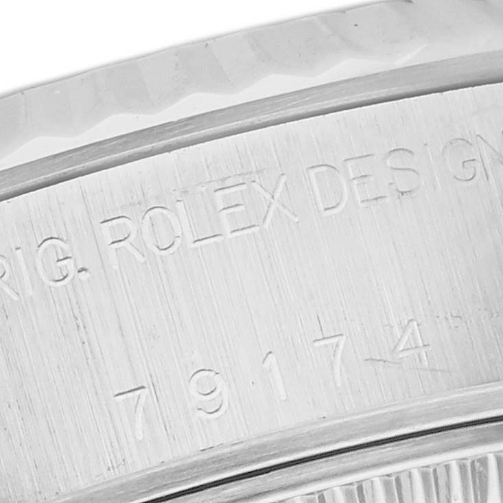 The image shows a close-up of the serial number and "ORIG. ROLEX DESIGN" engraving on the case of a Rolex Datejust 79174 Women
s Stainless Steel Mother of Pearl Dial 79174 Women
s Stainless Steel Mother of Pearl Dial watch.