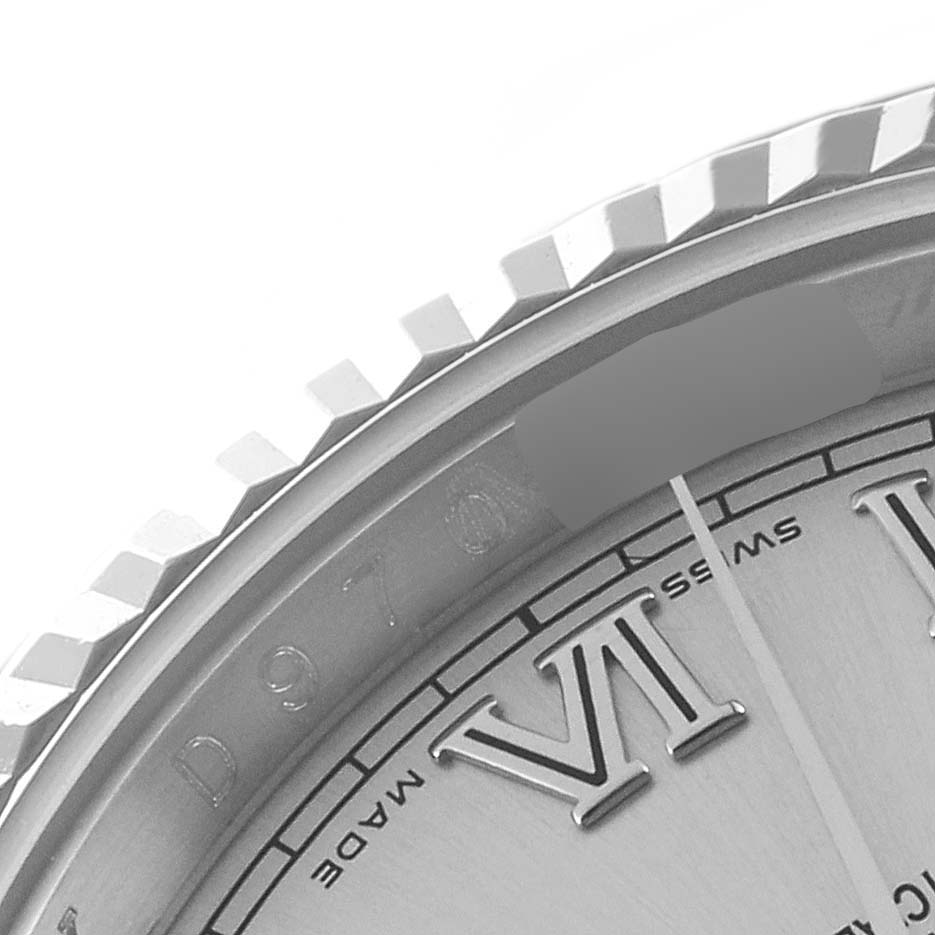This close-up image of a Rolex Datejust 116234 Men's Stainless Steel Silver Dial 116234 Men's Stainless Steel Silver Dial model shows the bezel, part of the dial, and the Roman numeral VI.