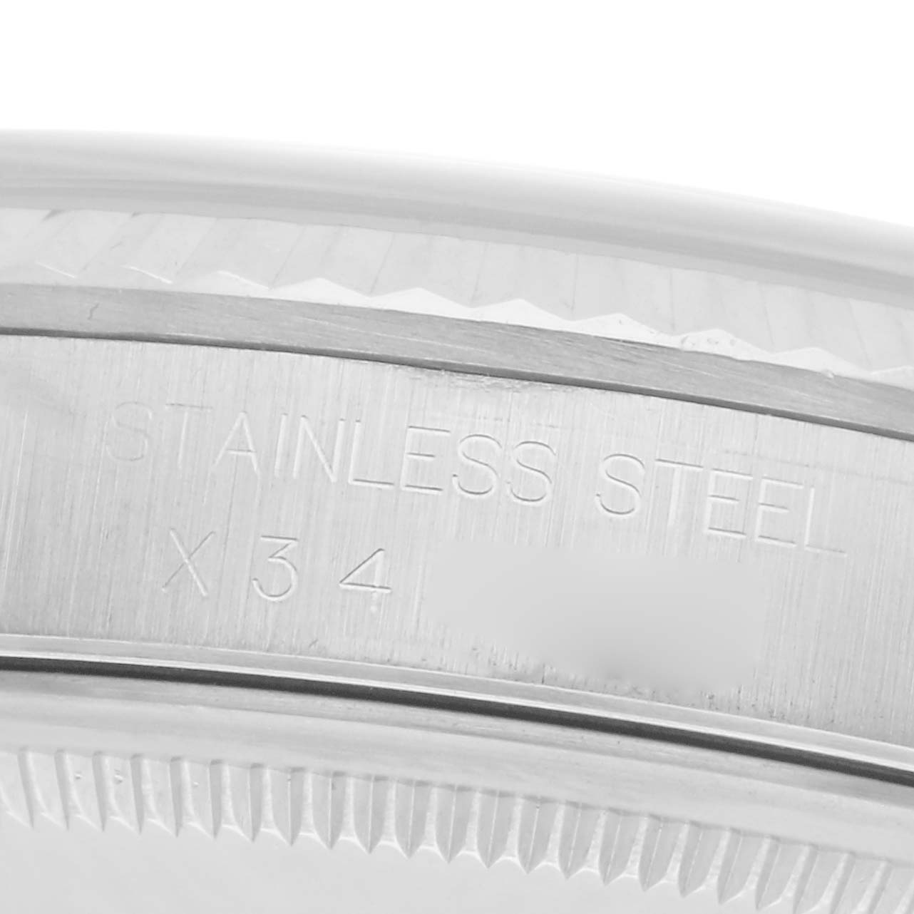 The image shows a close-up of the stainless steel engraved part of the Rolex Datejust 16234 Men
s Stainless Steel White Dial 16234 Men
s Stainless Steel White Dial watch case.