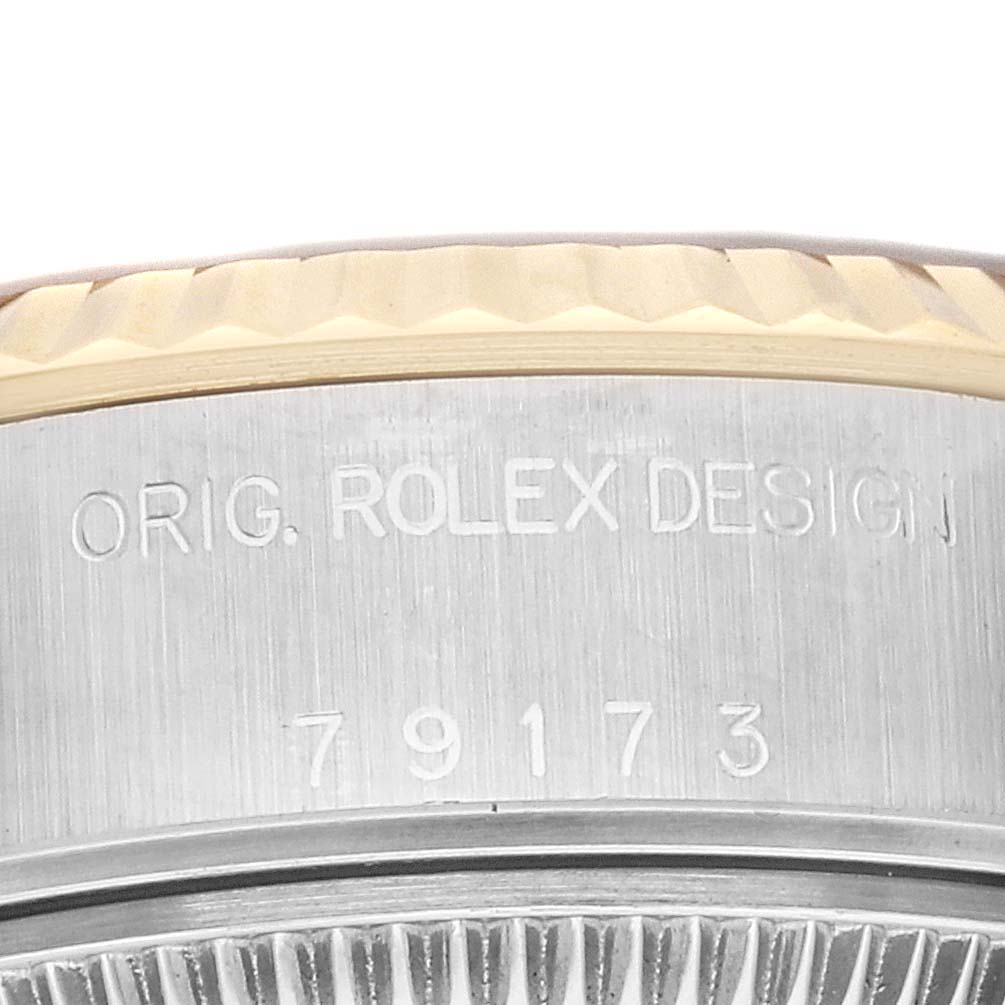 This image shows a close-up of the case back and bezel of a Rolex Datejust 79173 Women's Steel and Gold (two tone) Blue Dial 79173 Women's Steel and Gold (two tone) Blue Dial watch.