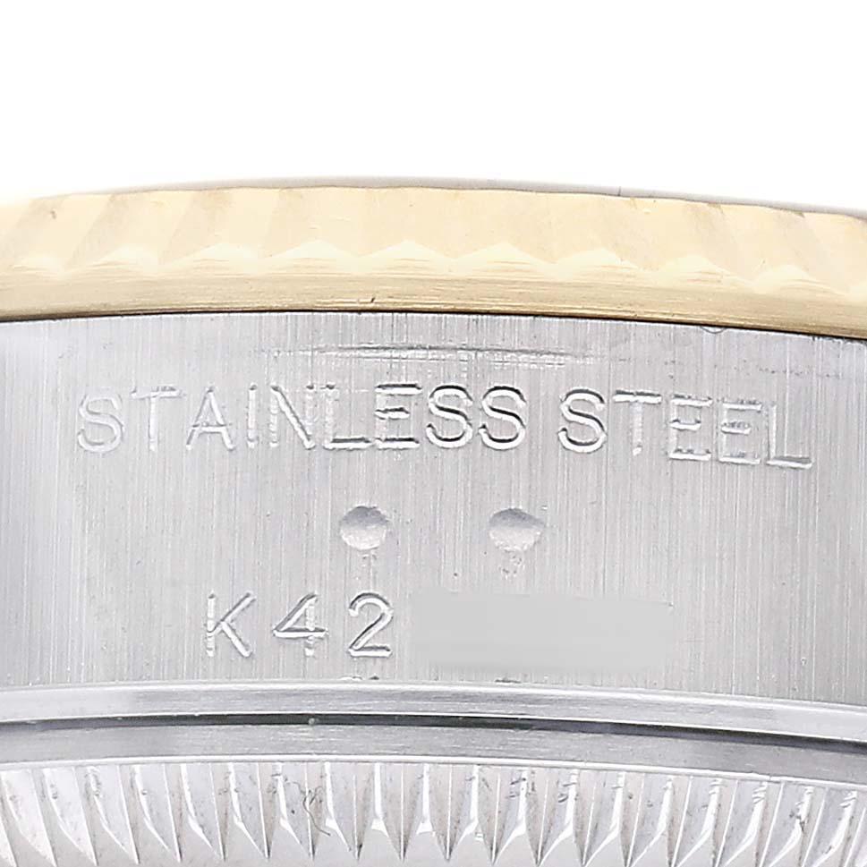The image shows a close-up of the side of a Rolex Datejust 79173 Women's Stainless Steel Champagne Dial watch case, highlighting the stainless steel material and engravings.