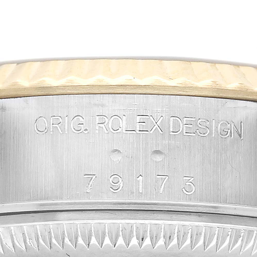 The image shows a close-up of the side of a Rolex Datejust 79173 Women's Stainless Steel Champagne Dial, featuring the model number and "ORIG. ROLEX DESIGN" engraving.