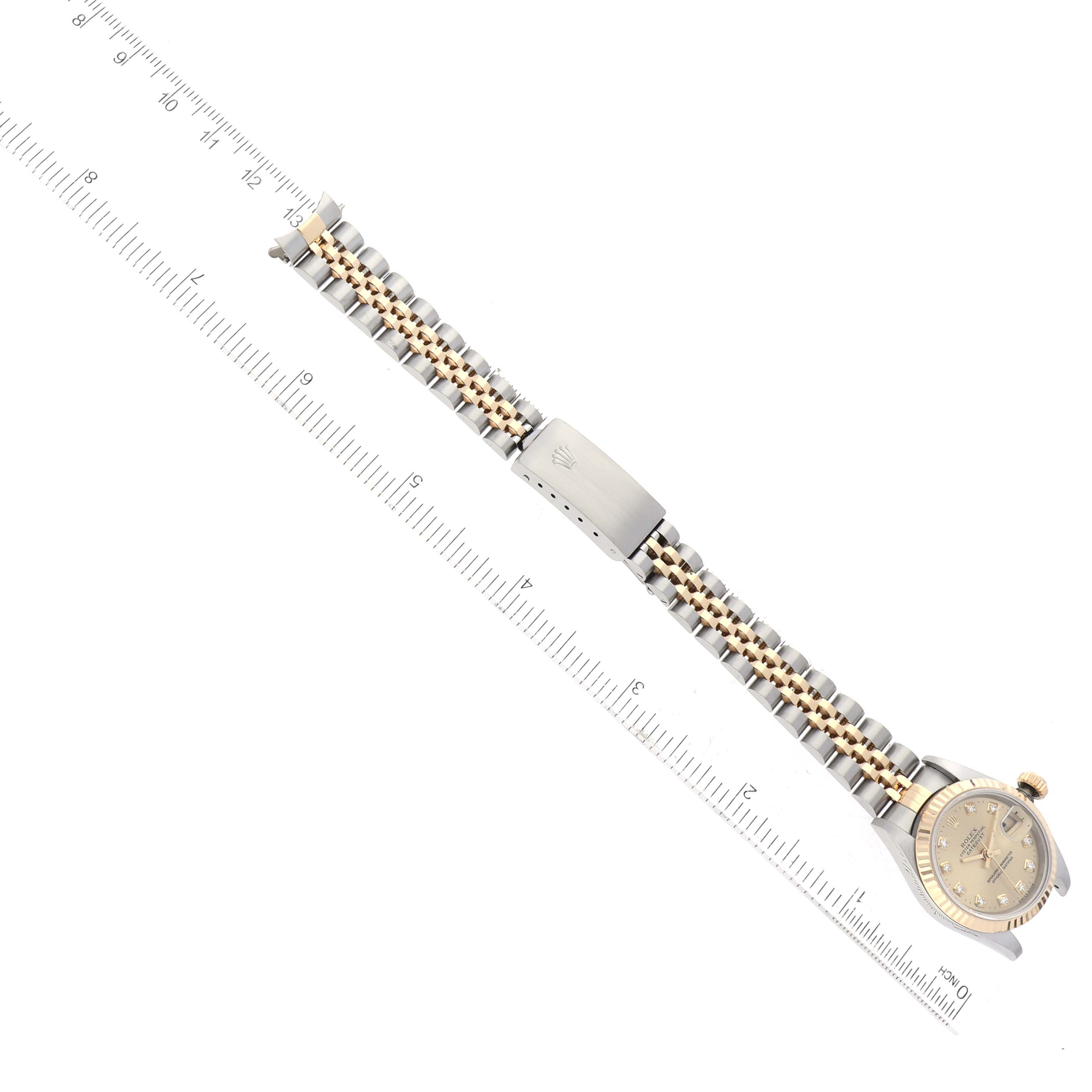 The image shows a full top view of a Rolex Datejust 69173G Women's Steel and Gold (two tone) Champagne Dial 69173G Women's Steel and Gold (two tone) Champagne Dial watch with a ruler for scale.