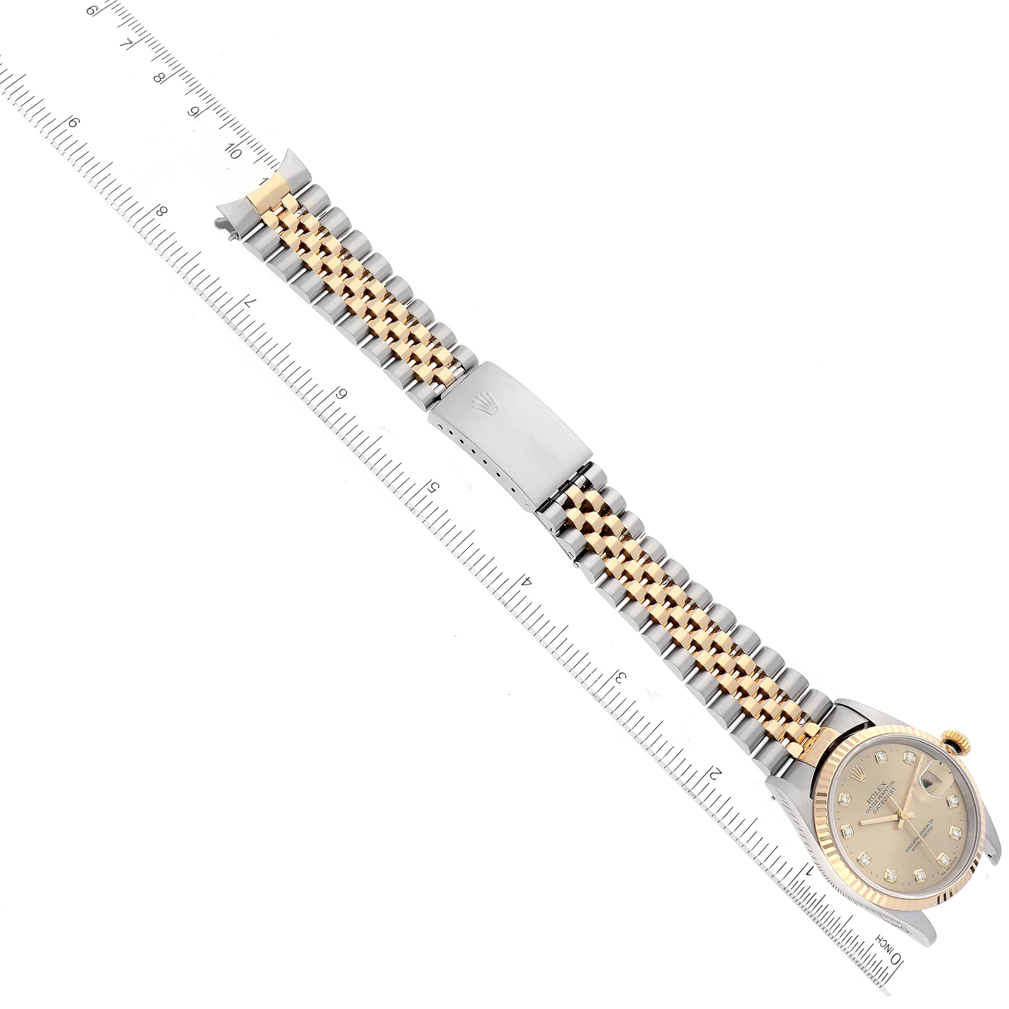 The image shows a Rolex Datejust 16233 Men's Steel and Gold (two tone) Champagne Dial 16233 Men's Steel and Gold (two tone) Champagne Dial watch lying flat with the face and bracelet fully extended, alongside a ruler for size reference.