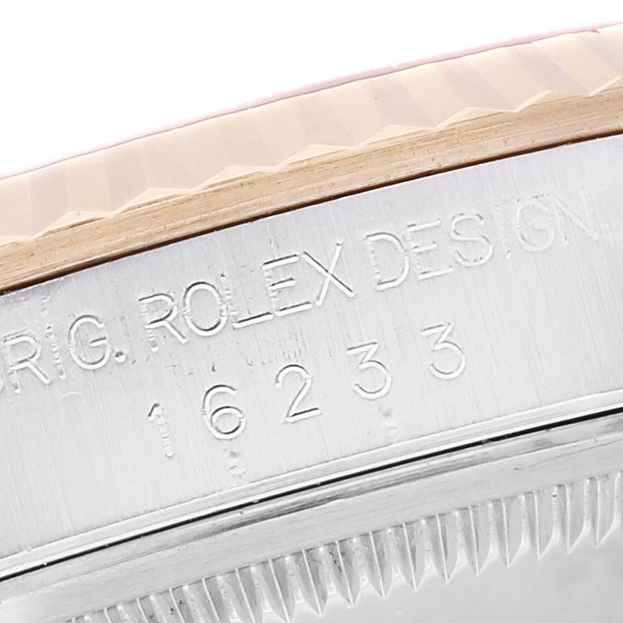 The image shows a close-up of the side engraving and fluted bezel of a Rolex Datejust 16233 Men's Steel and Gold (two tone) Champagne Dial 16233 Men's Steel and Gold (two tone) Champagne Dial model, showcasing model number 16233.
